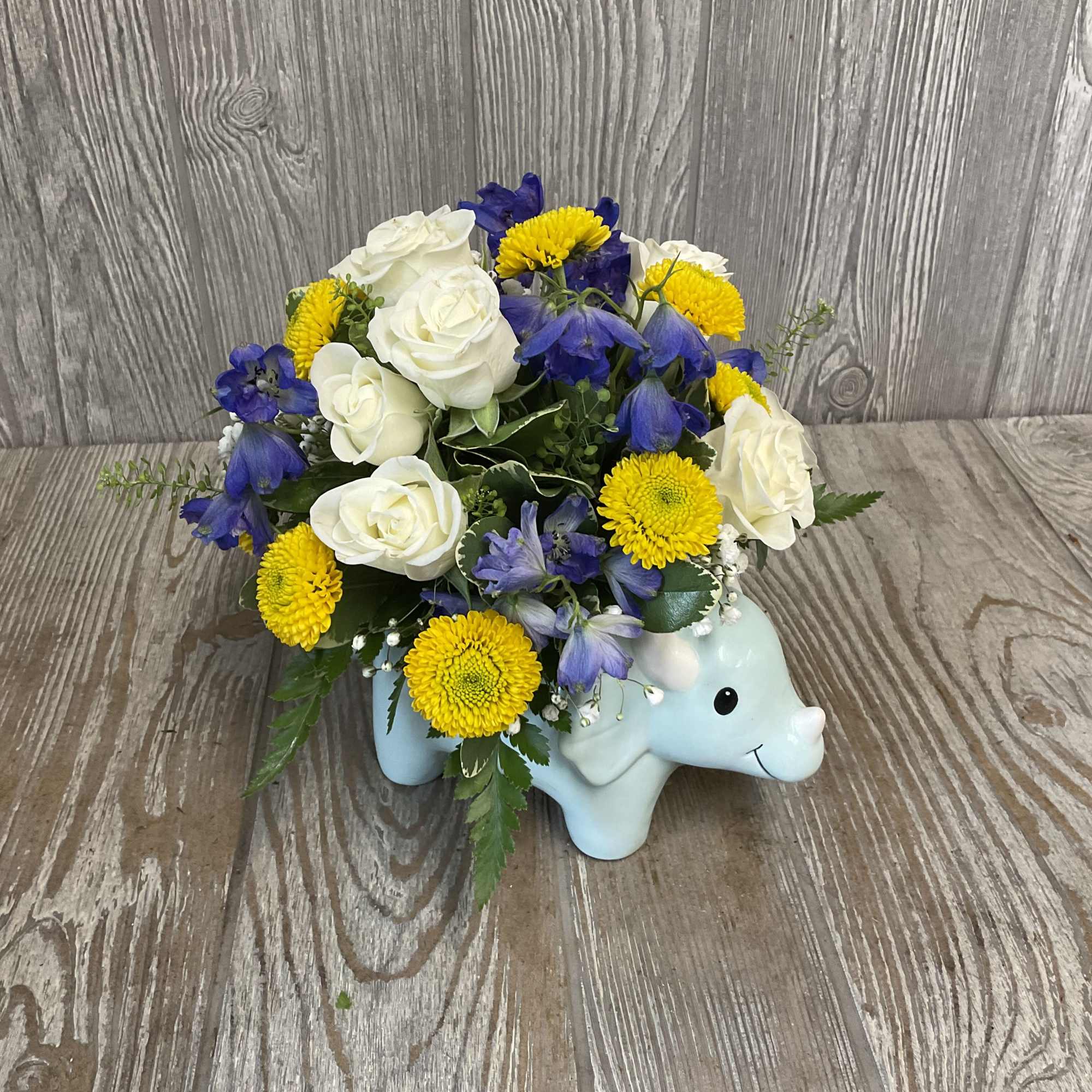 Welcome Dino! These floral arrangements, in ceramic keepsake dinosaur containers, are the
