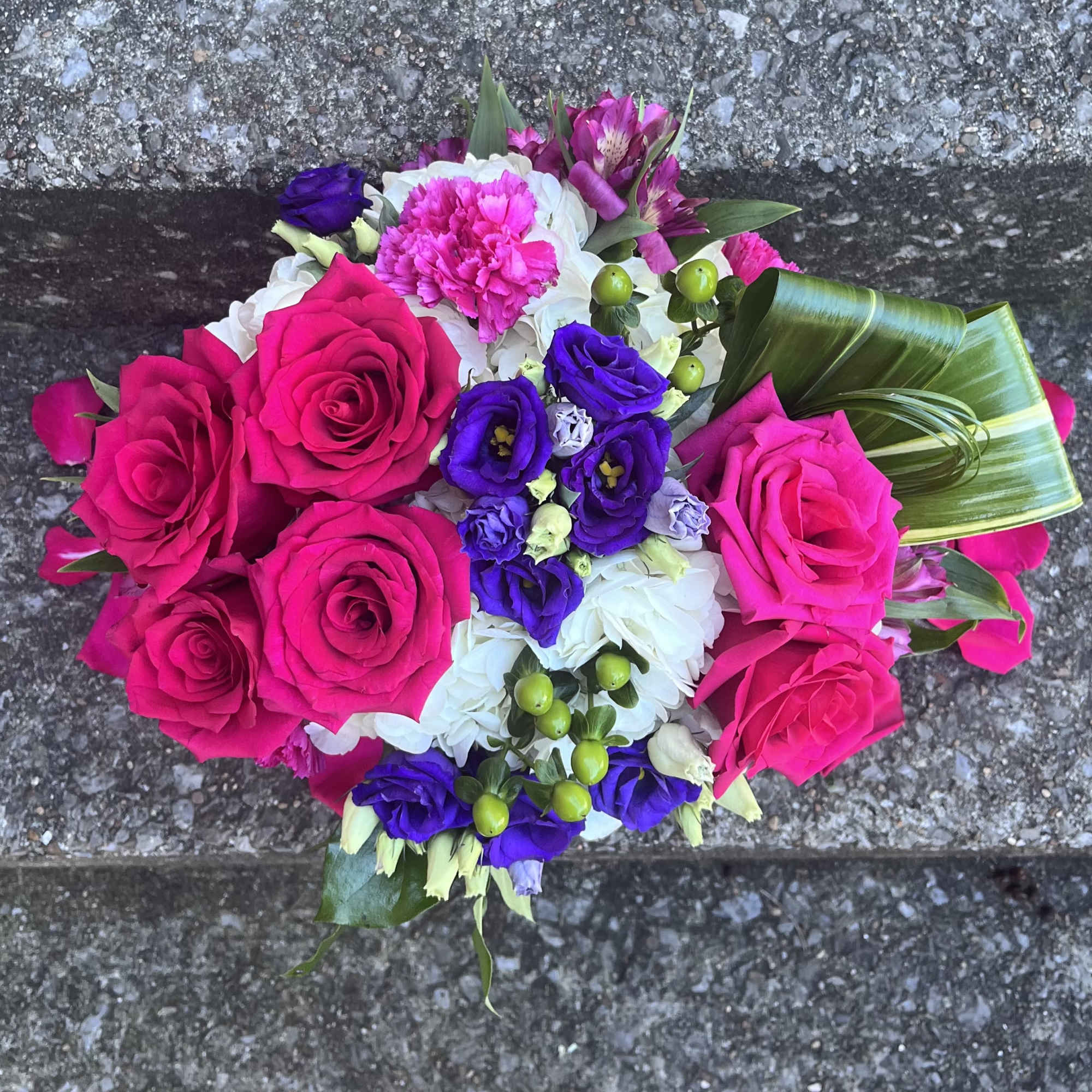 This beautifully designed arrangement is filled with hydrangea, roses, Lisianthus, Hypericum, aspidistra