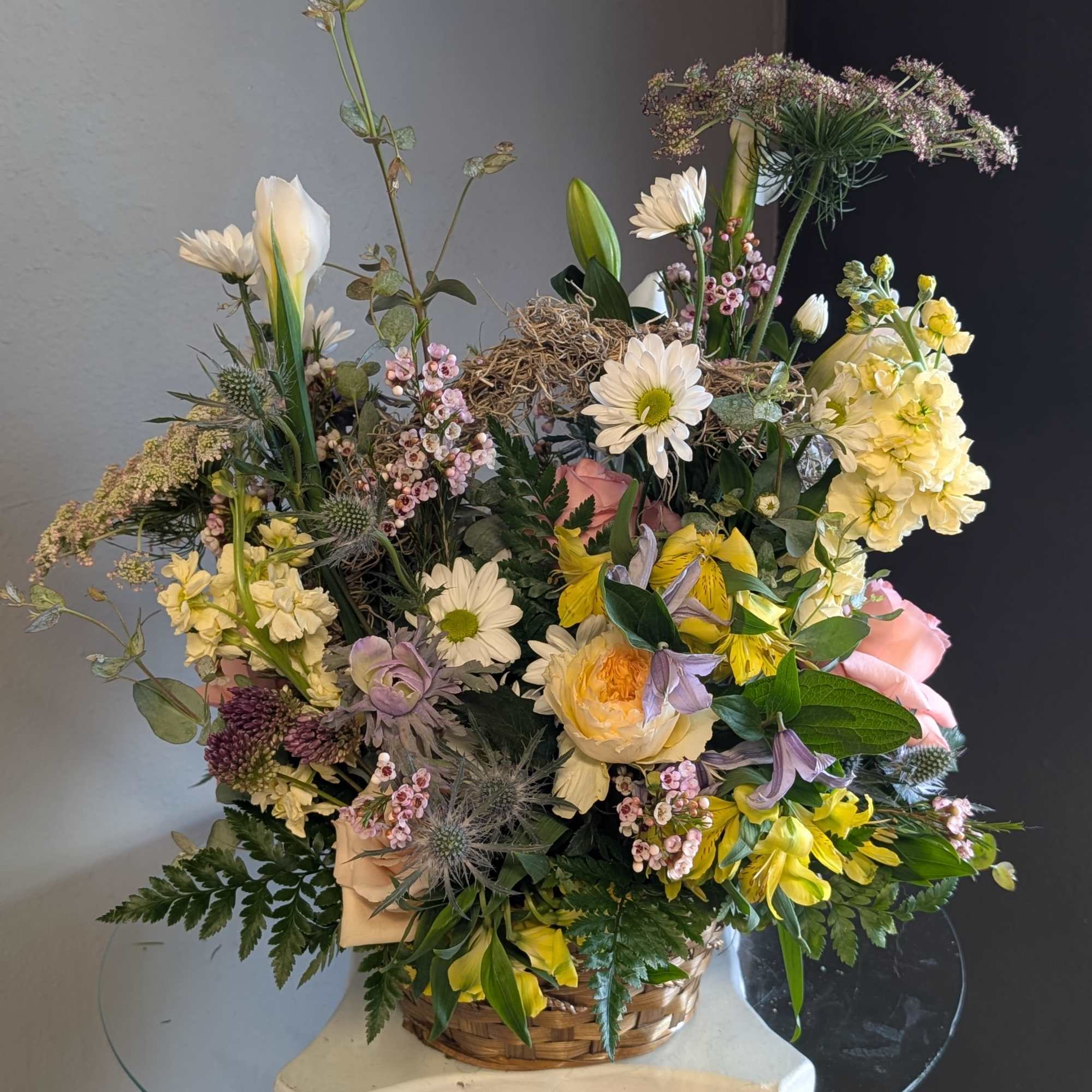 This beautiful flower arrangement of fresh mixed seasonal blooms is made by