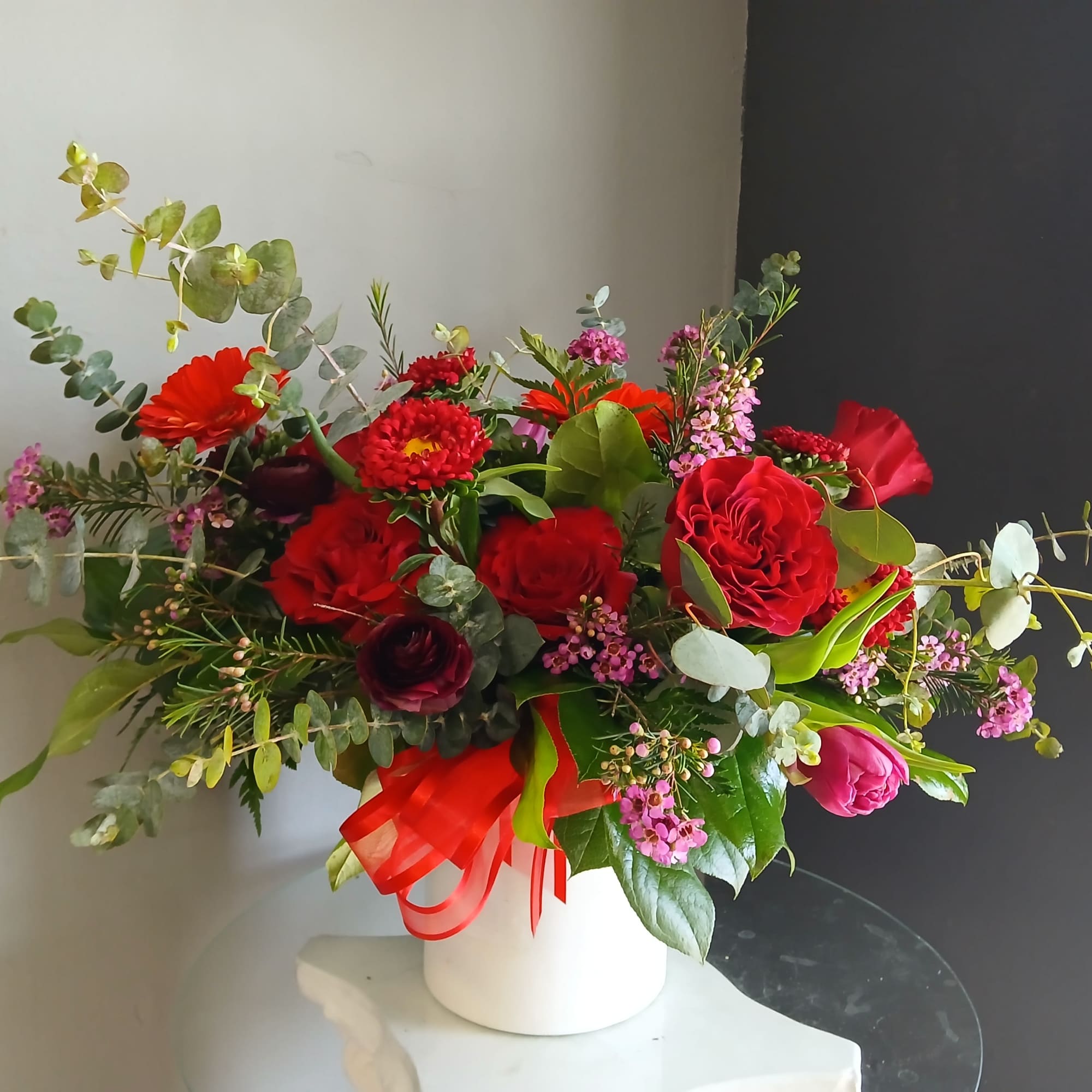 This beautiful flower arrangement of fresh mixed seasonal blooms is made by