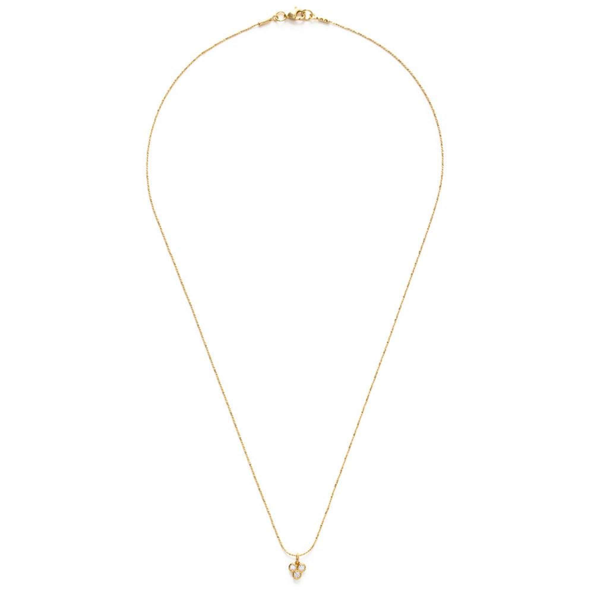 The Tiny Triple Crystal Necklace reflects a glint of light, a sparkle