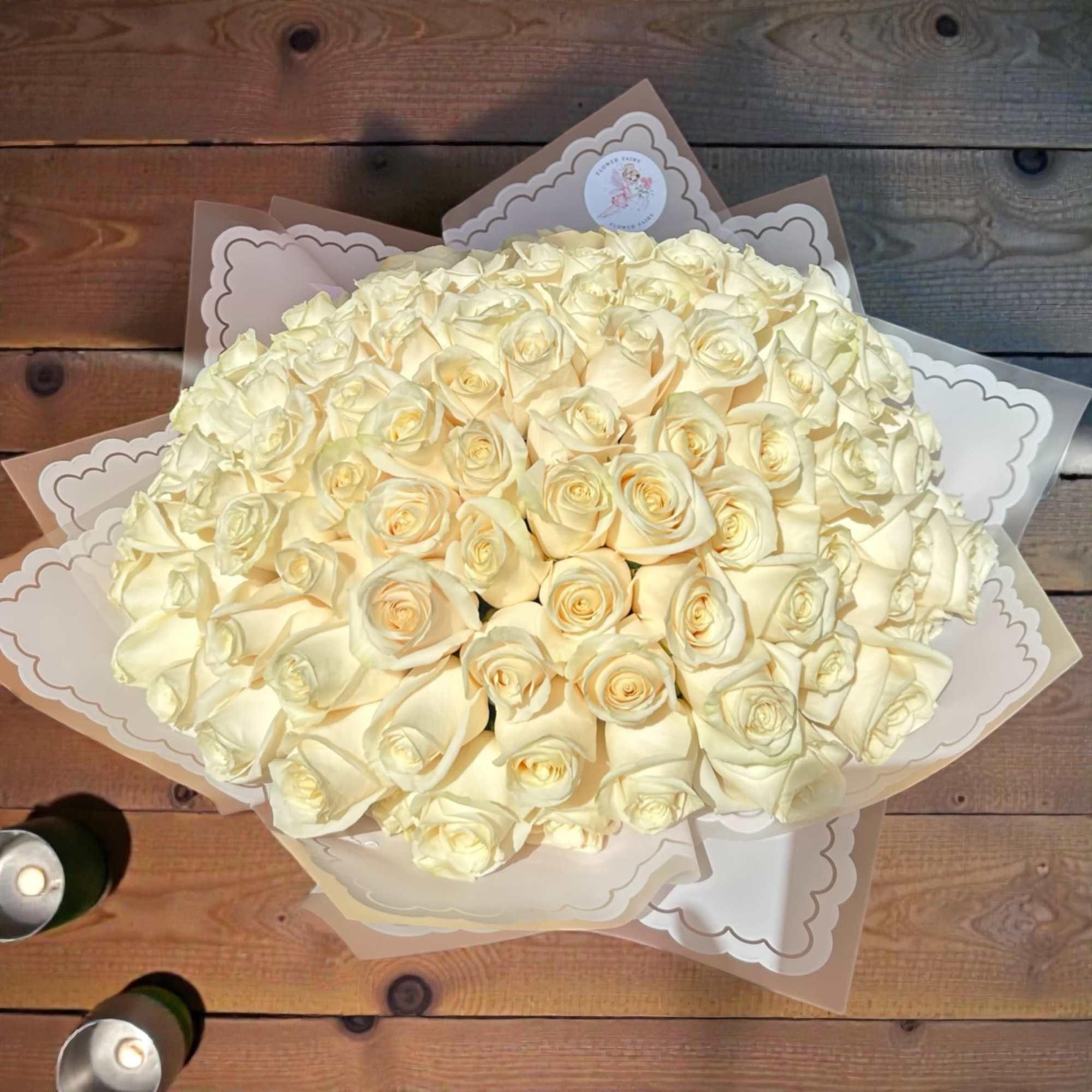 The Ramo Buch&oacute;n 100 Wrapped Roses Arrangement is a luxurious floral statement