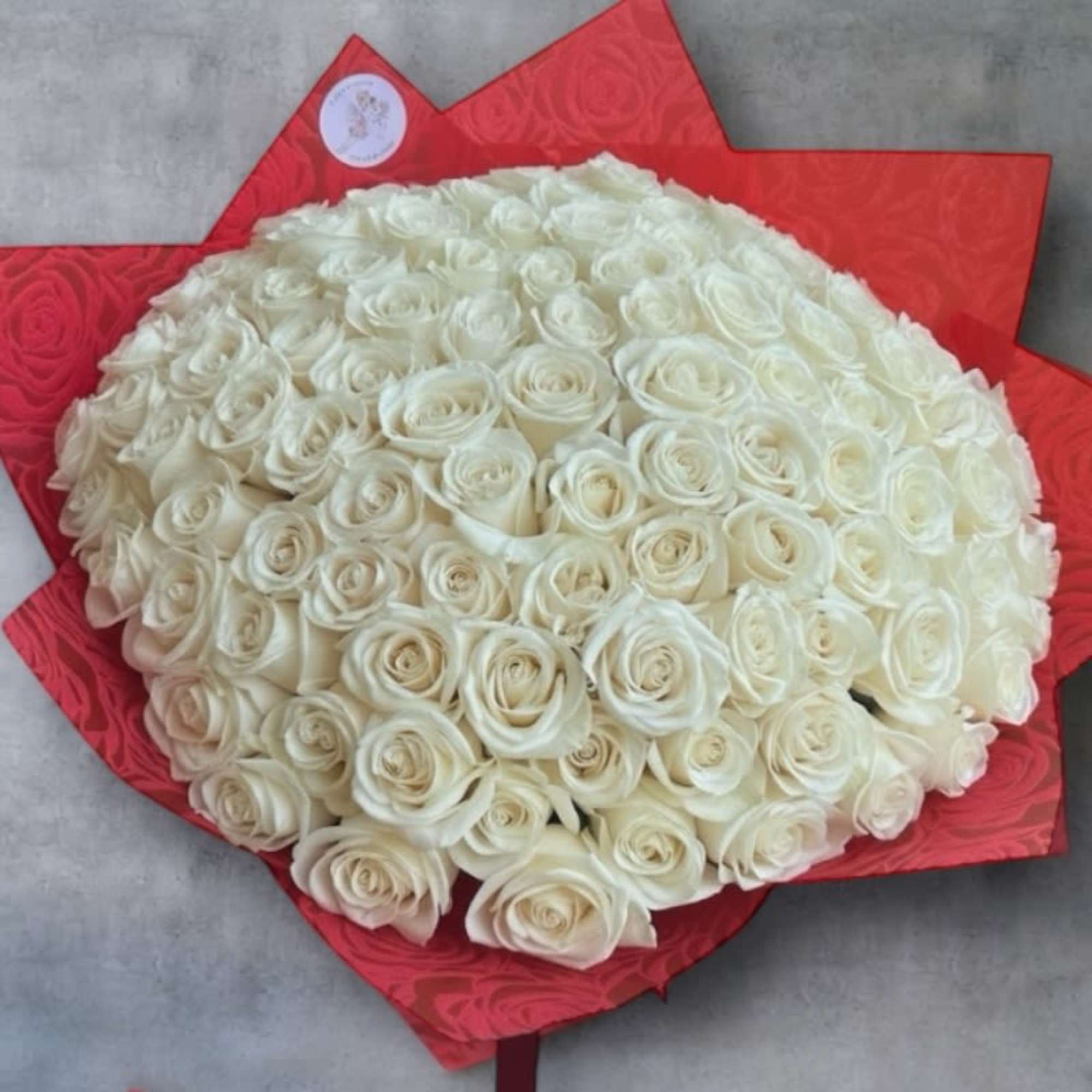 The Ramo Buch&oacute;n 100 Wrapped Roses Arrangement is a luxurious floral statement
