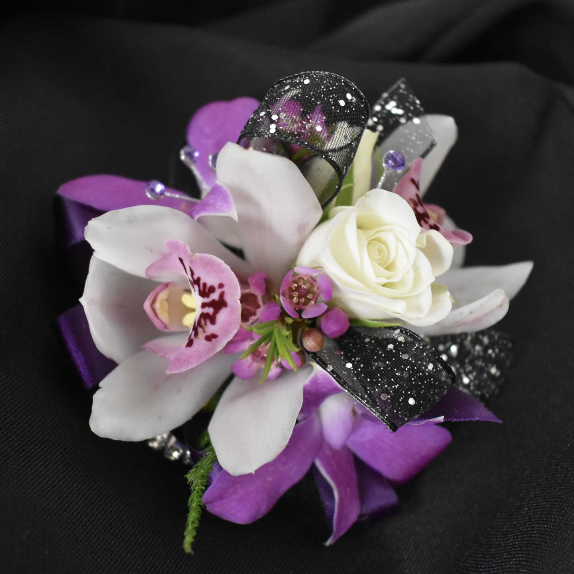 A rhinestone elastic wrist band with lavender, purple and white flowers. Please