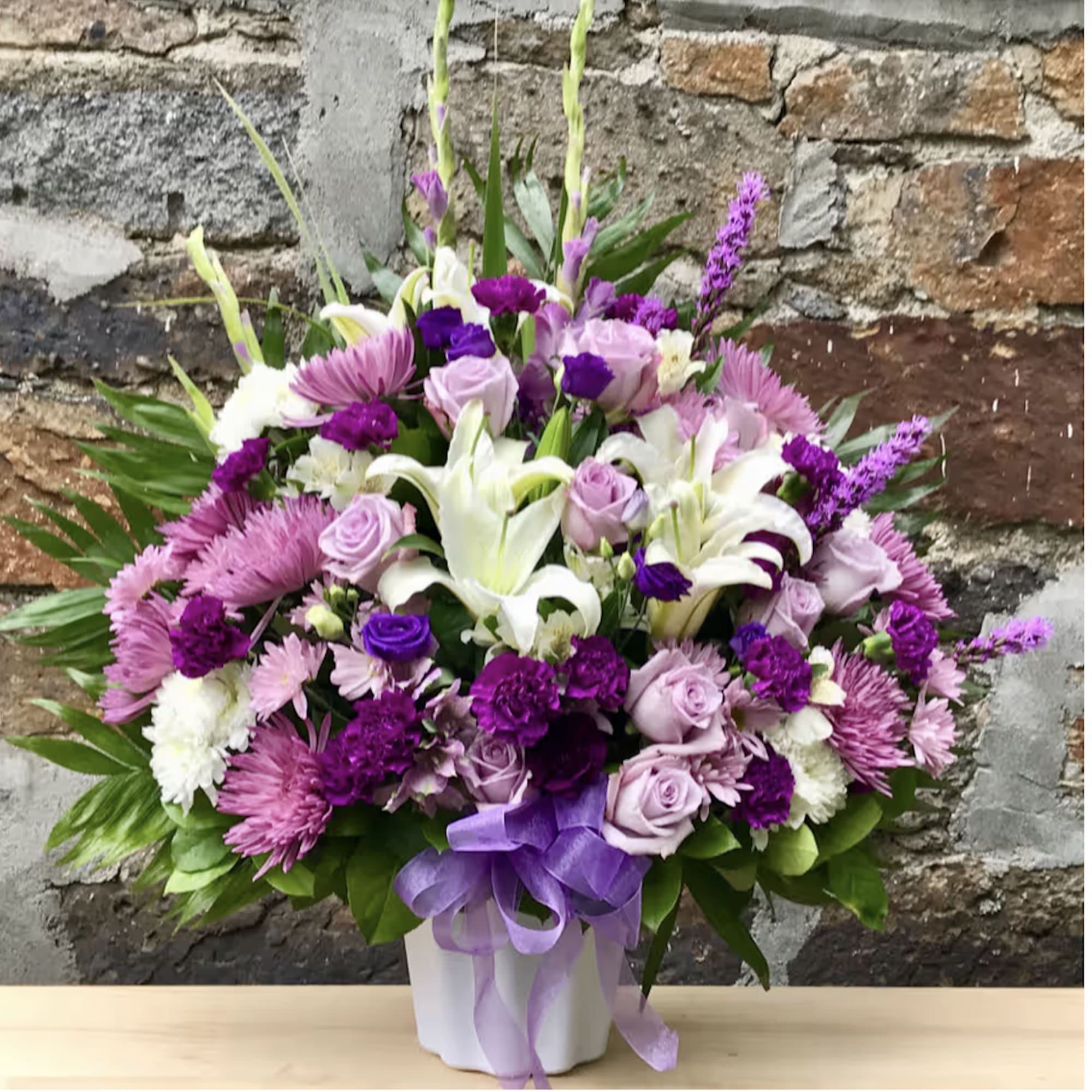 Flowers set into a triangular shape appropriate for sympathy arrangement