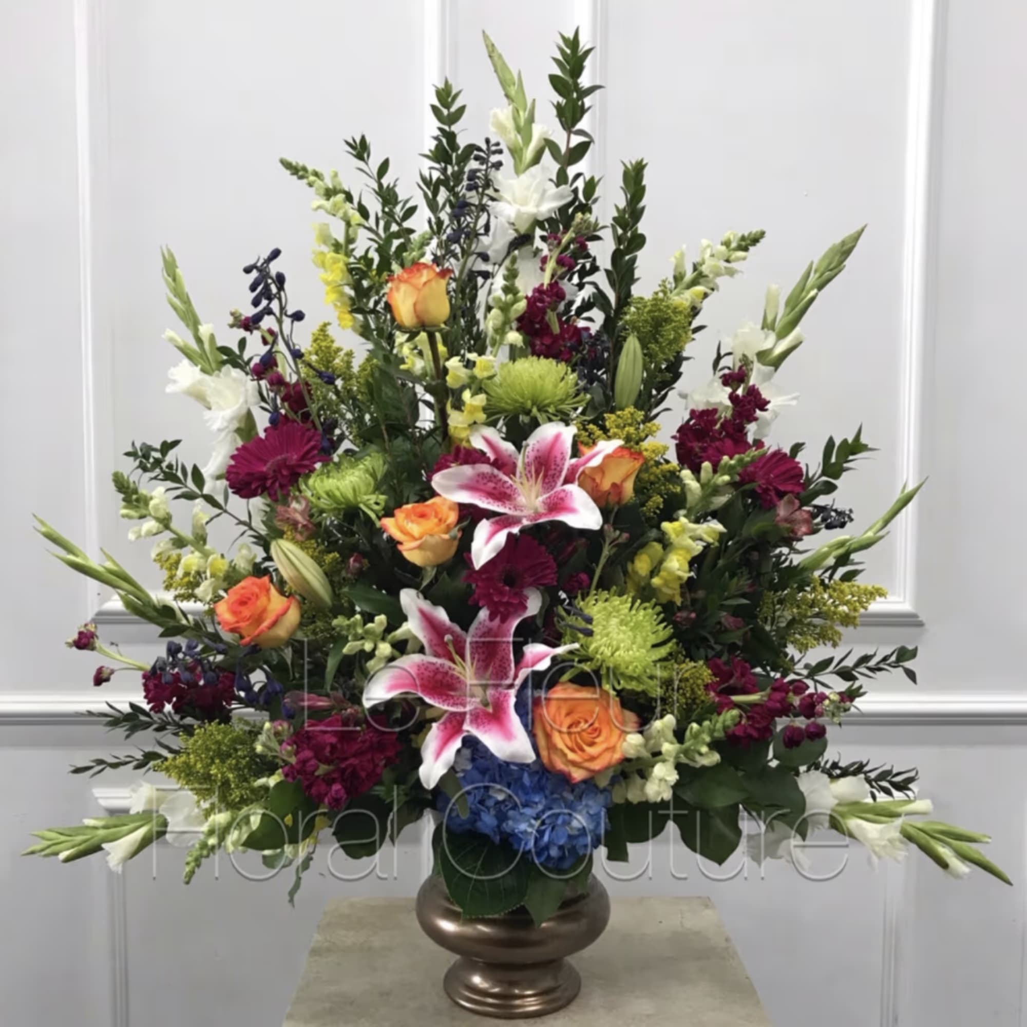 Flowers set into a triangular shape appropriate for sympathy arrangement