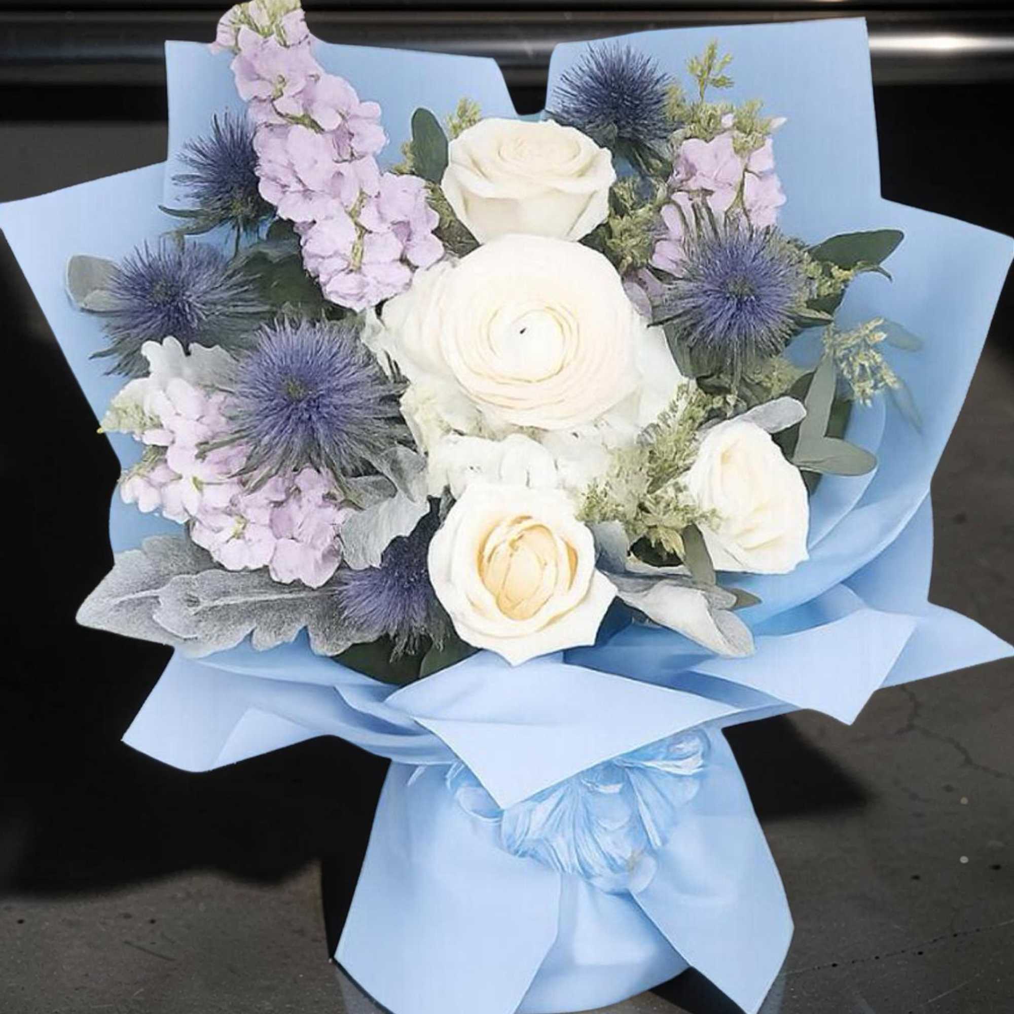 A beautiful hand-wrapped inspired by Columbia&rsquo;s signature blue, featuring elegant white roses