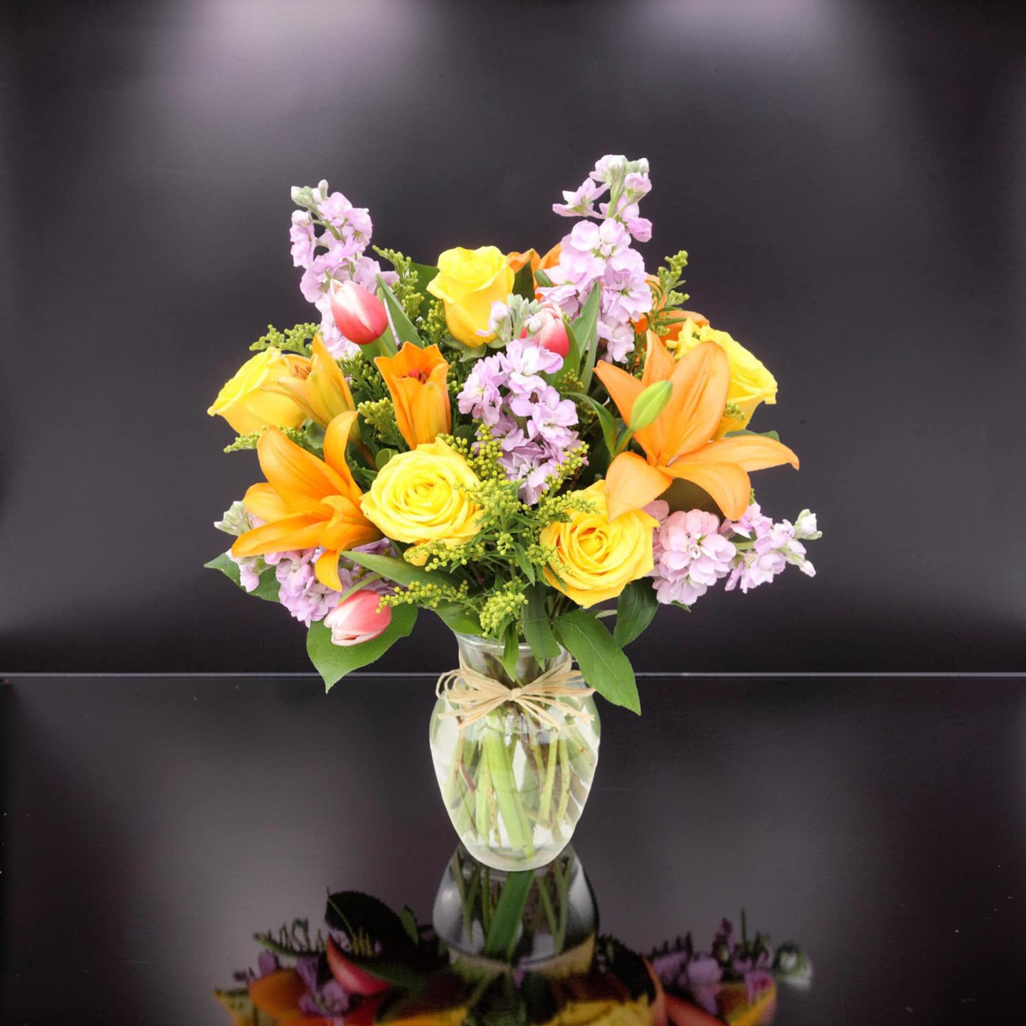 A vibrant and cheerful arrangement designed to brighten any space. Featuring radiant