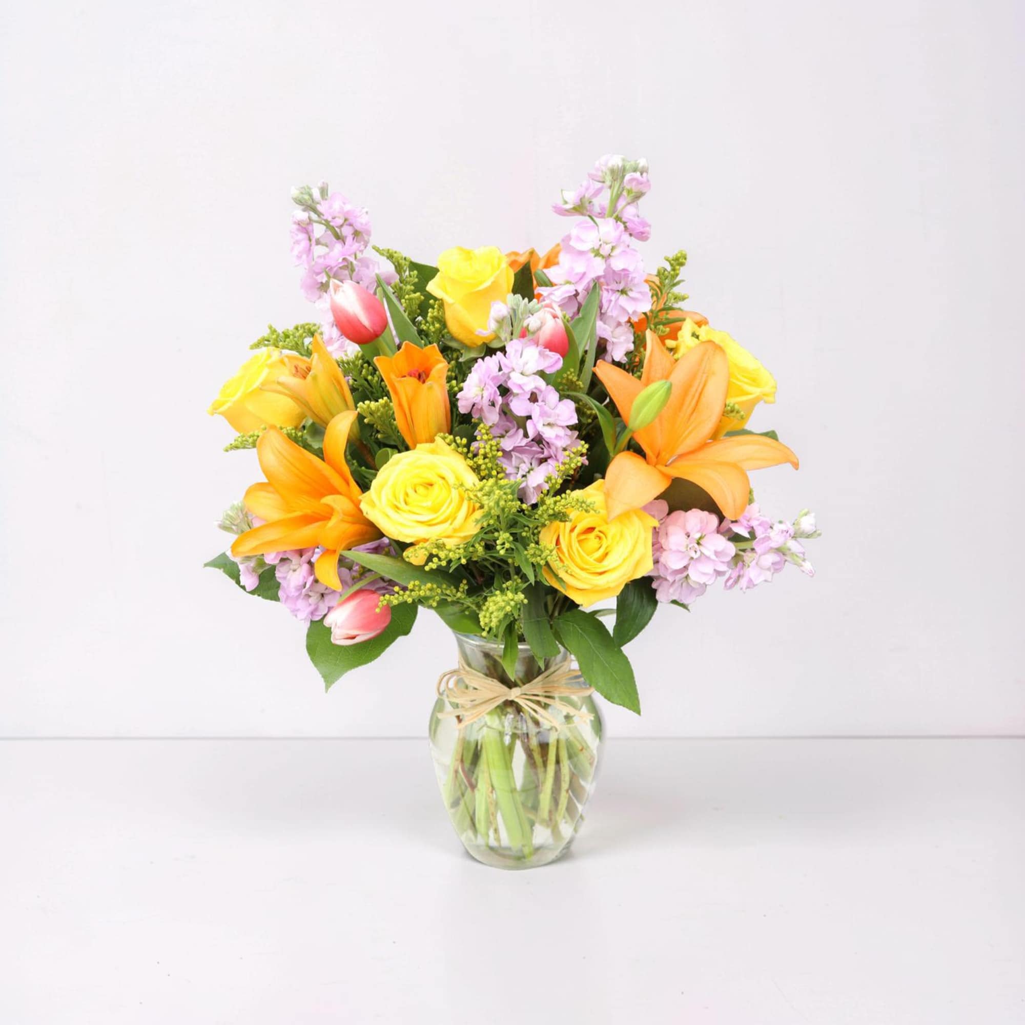 A vibrant and cheerful arrangement designed to brighten any space. Featuring radiant