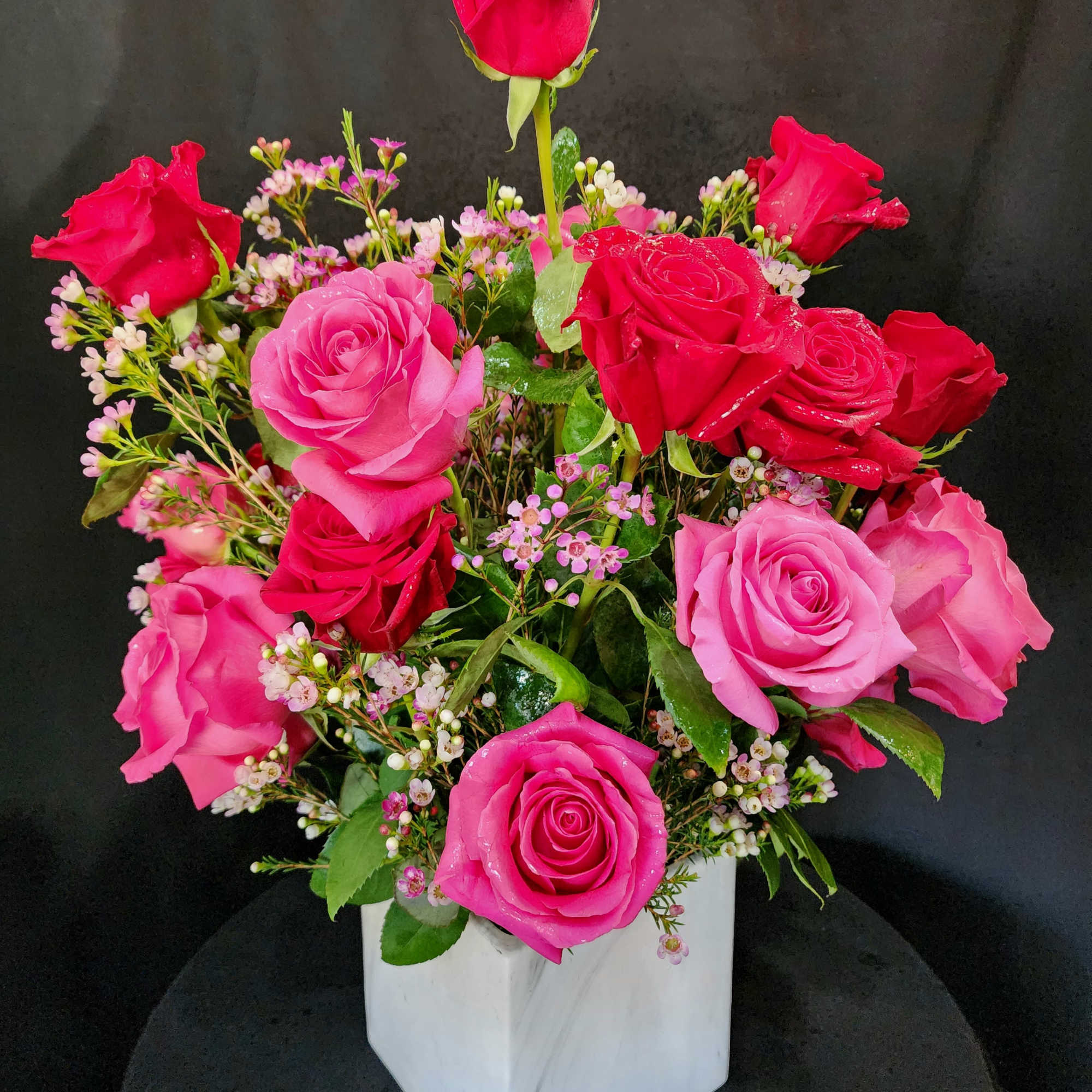 1 dozen large roses in a vase for the classic souls. Eriostemon