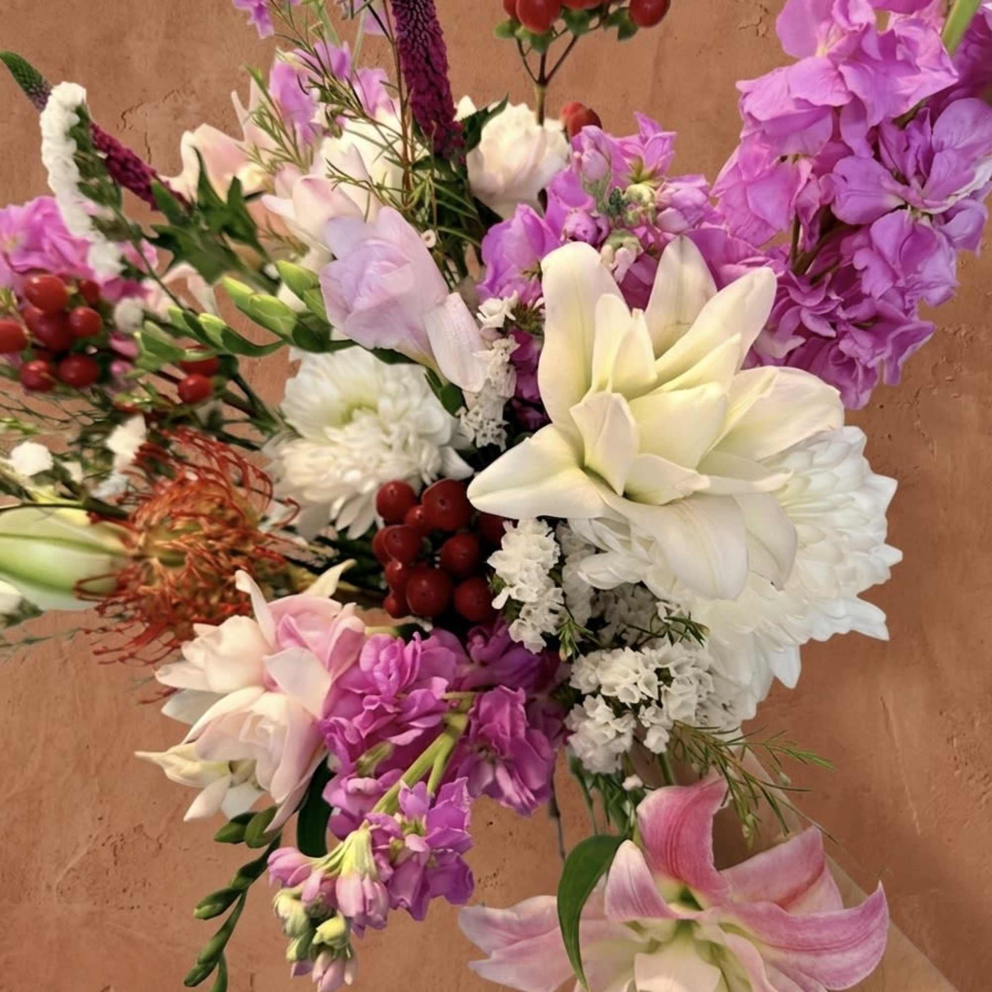 Centered around the architectural brilliance of the Pincushion Protea, The Crown Jewel