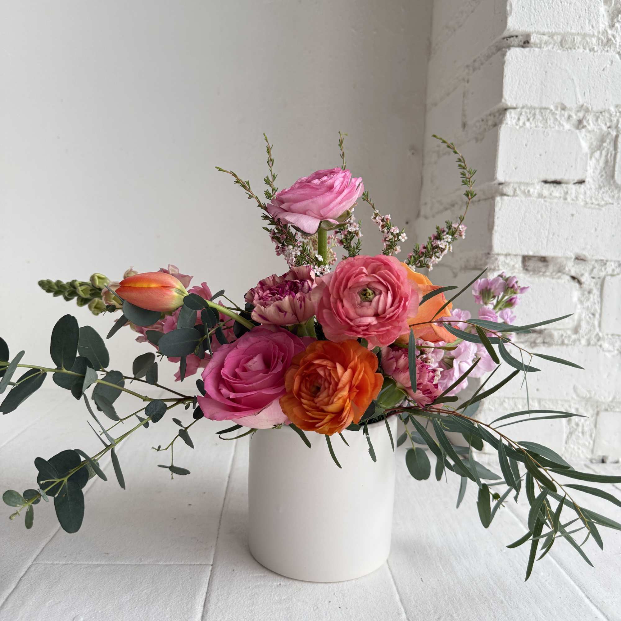 We artfully arrange blooms in bright bold shades of orange, pinks and