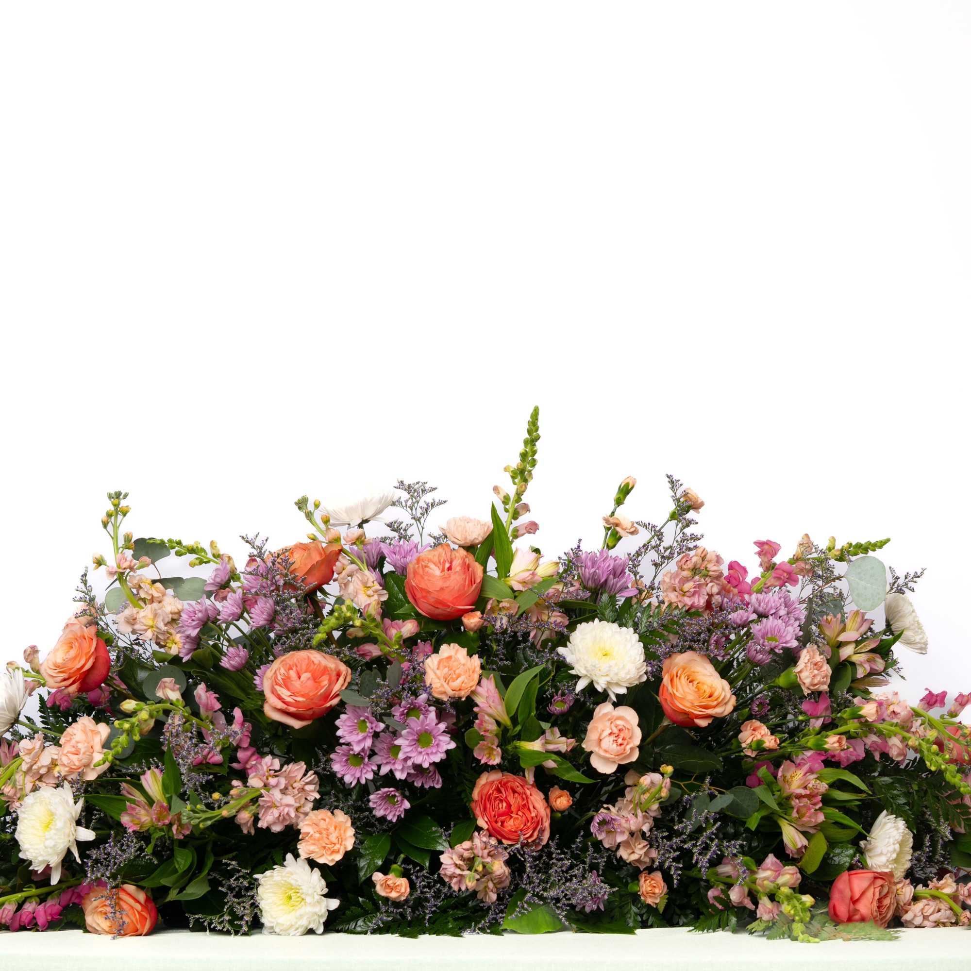 Soft and expressive, this large, pastel casket spray offers a gentle and