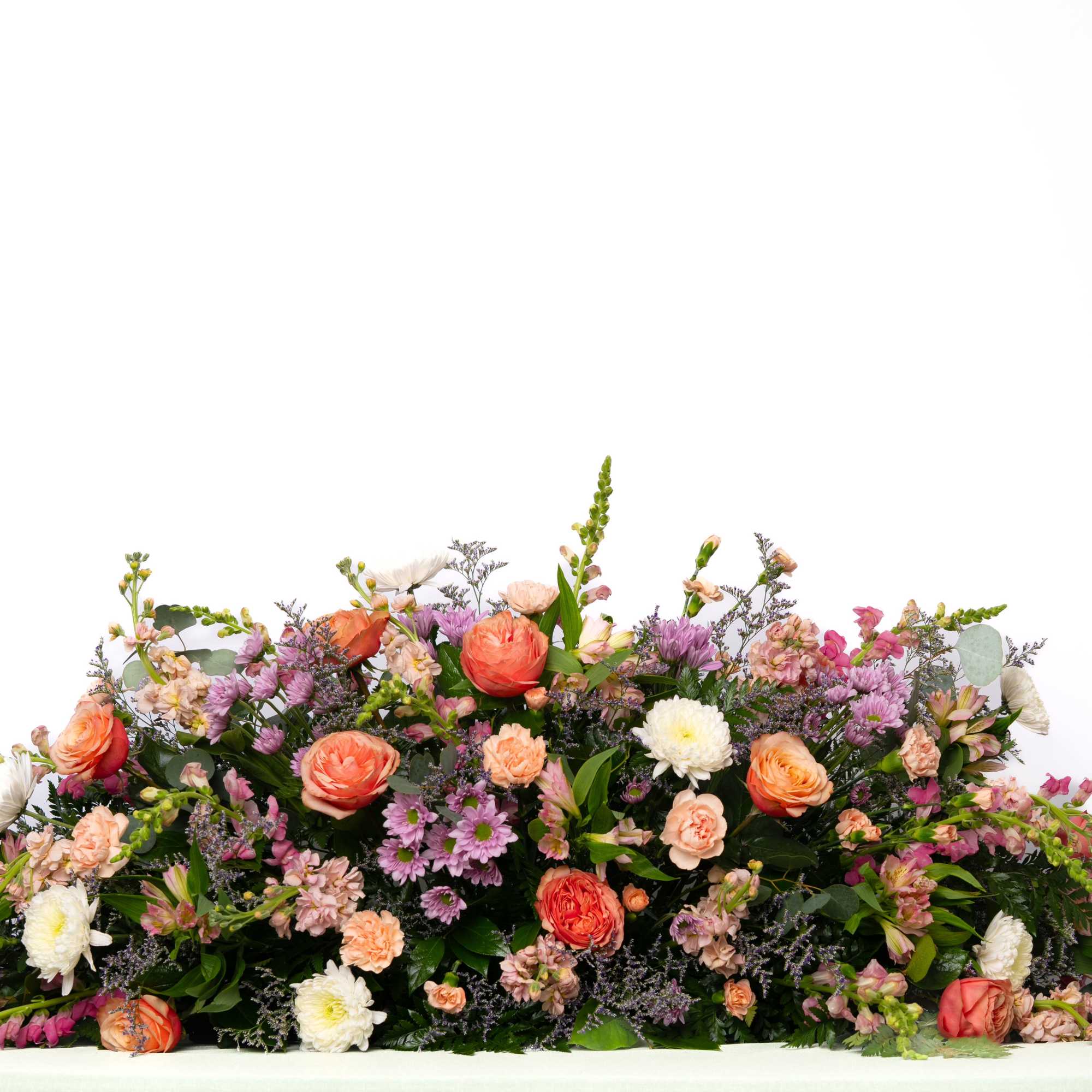 Soft and expressive, this large, pastel casket spray offers a gentle and