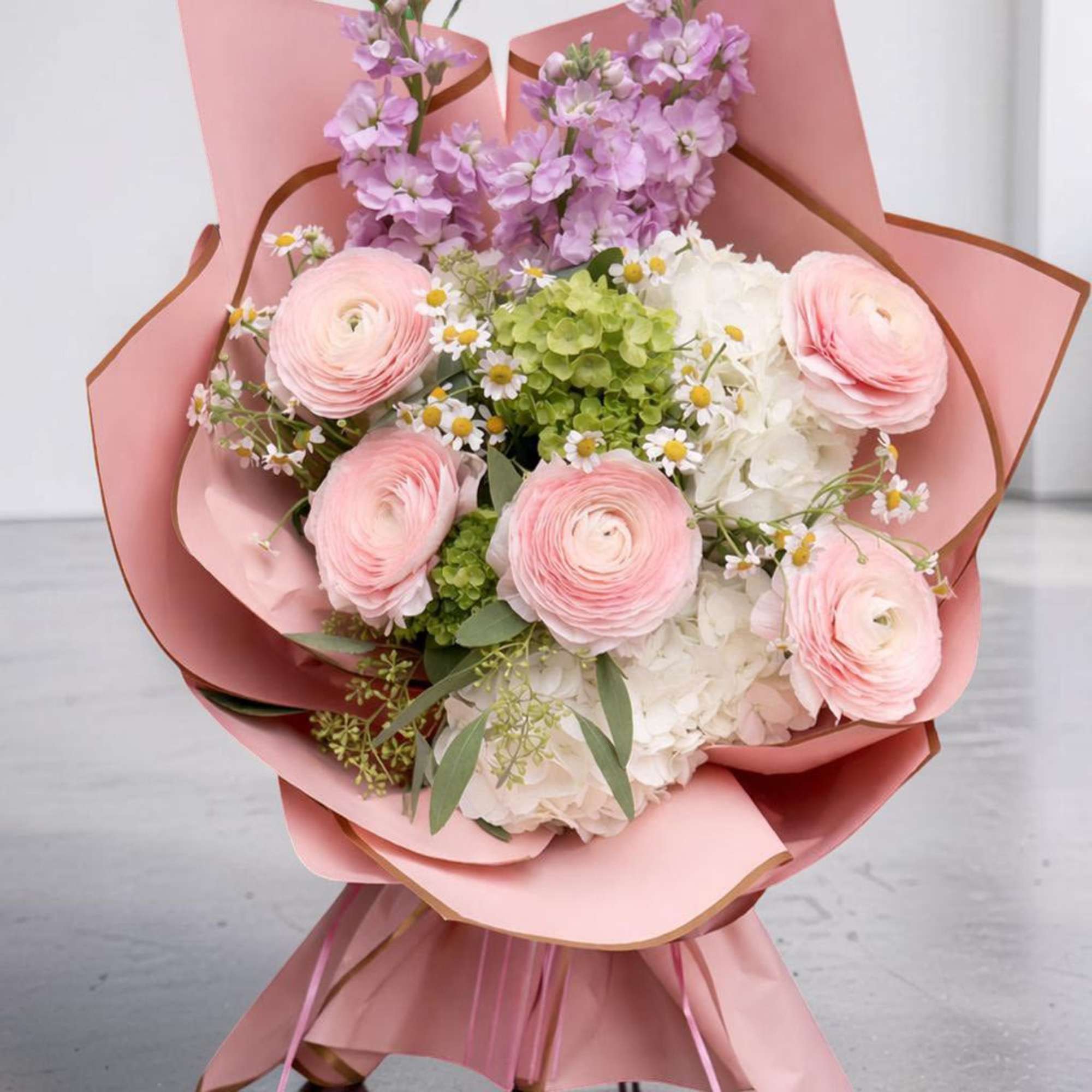 A soft and elegant hand-wrapped bouquet designed especially for Columbia University graduates.
