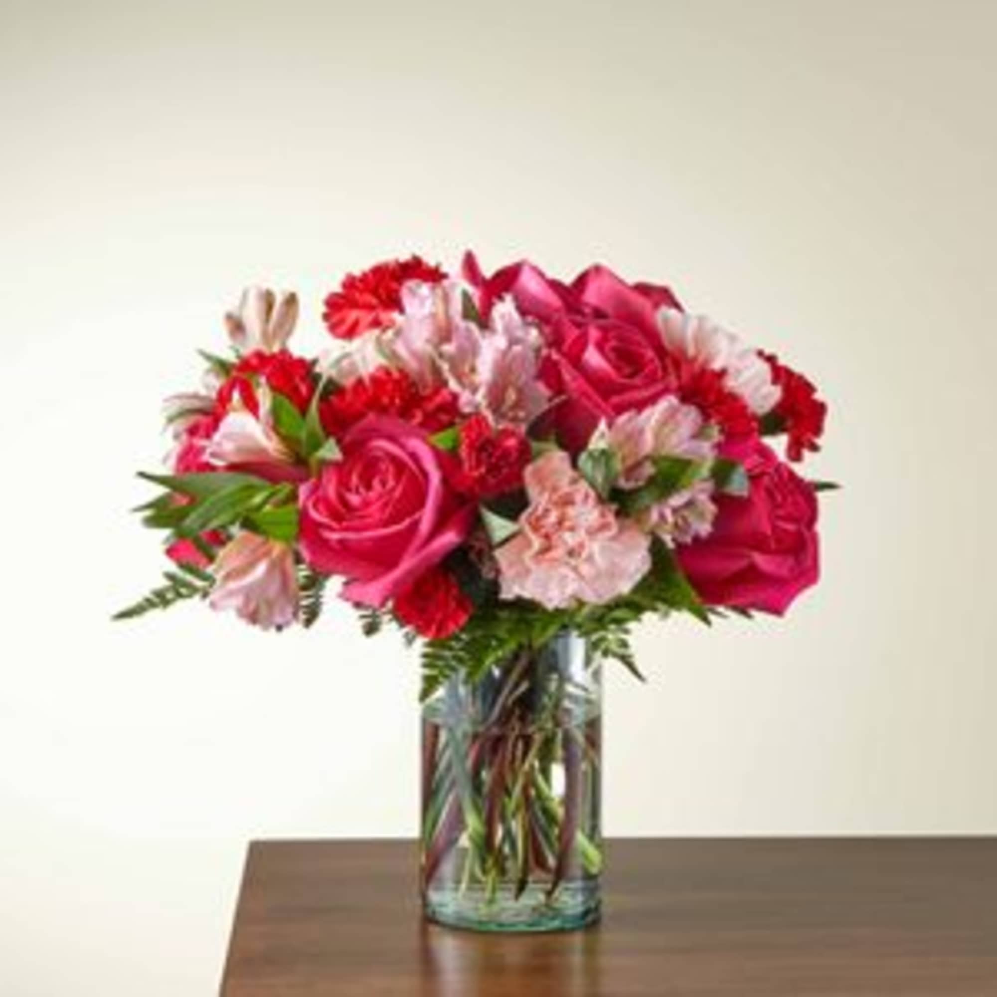 Valentine's mix of roses, alstroemeria, and carnations in pinks and reds...
