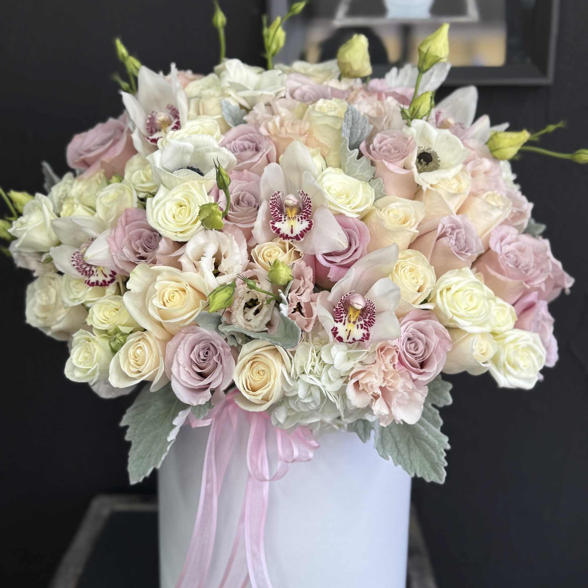 An elegant floral arrangement featuring a blend of pure white and vibrant