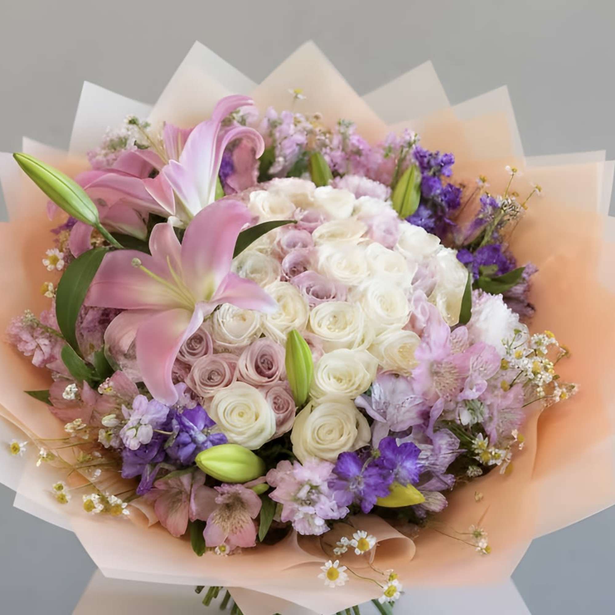 This exquisite bouquet features an enchanting array of pastel-colored roses, each blossom