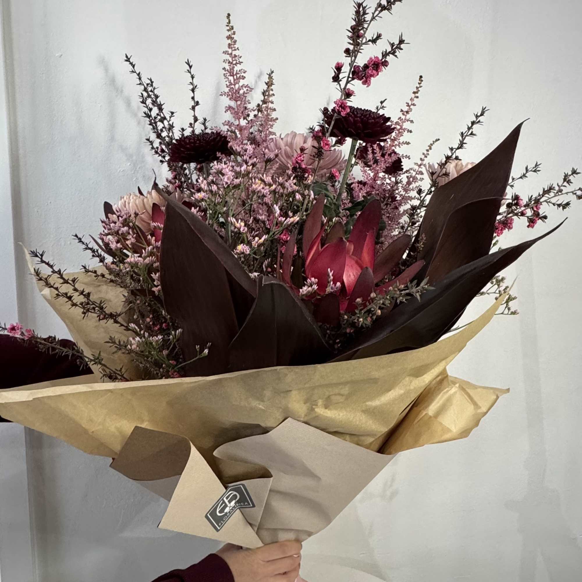 This colosal tied bouquet is a modern mixture of pinks and magentas