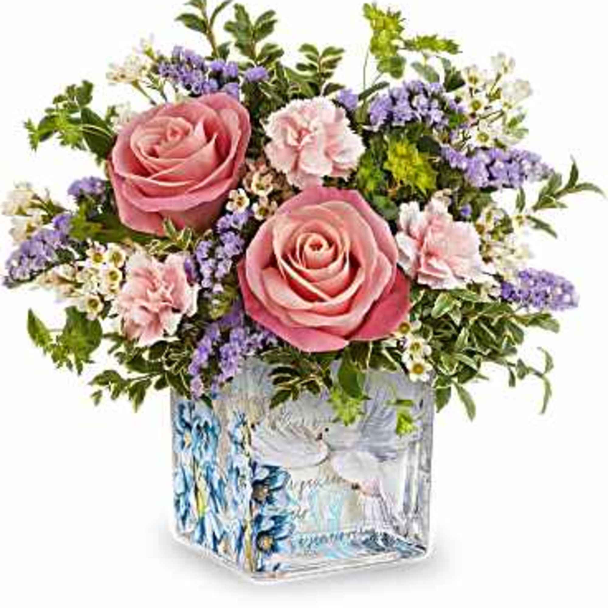 Soft pink roses anchor a low, rounded arrangement that reads like a