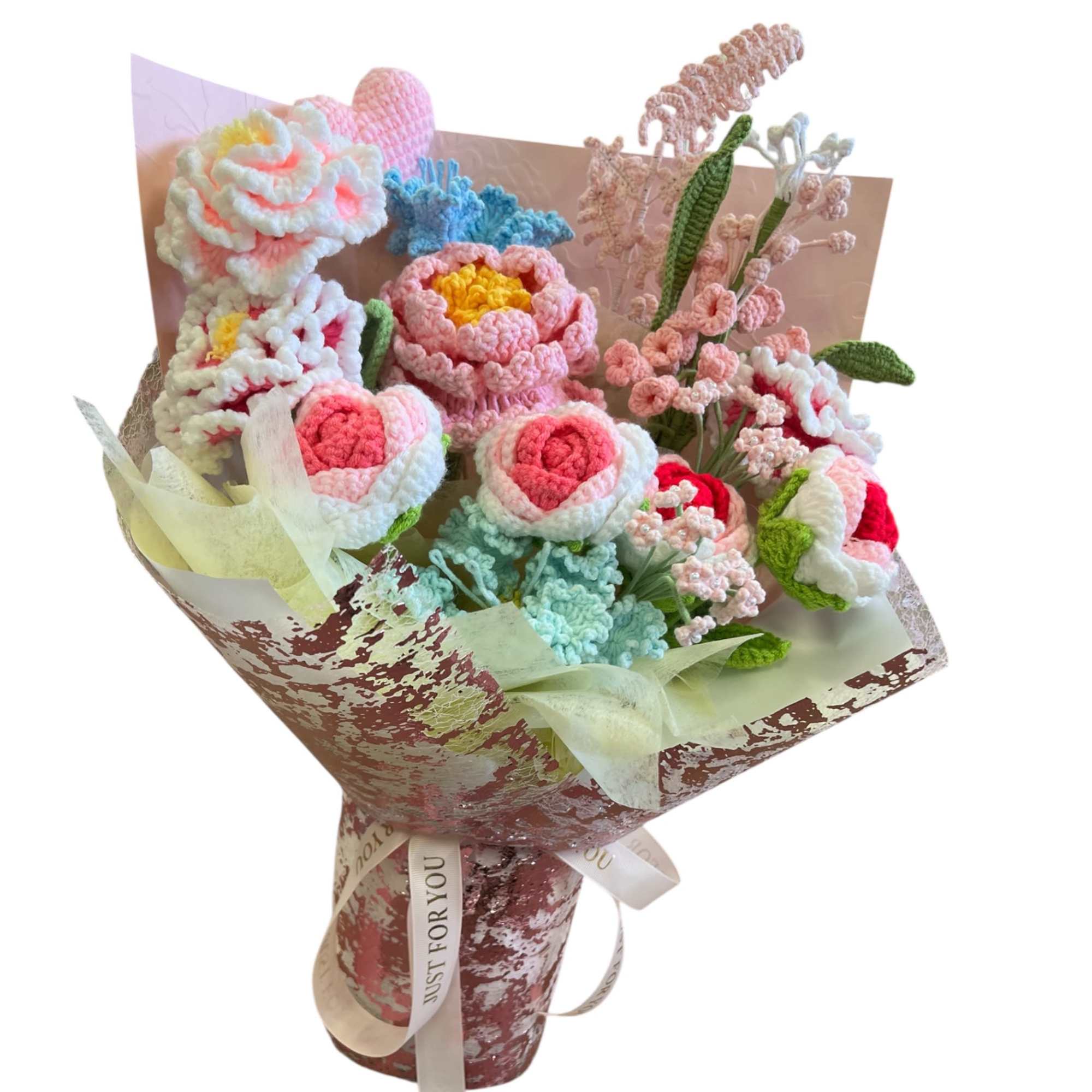 A variety of hand-knitted pink and pastel flowers, including roses and more
