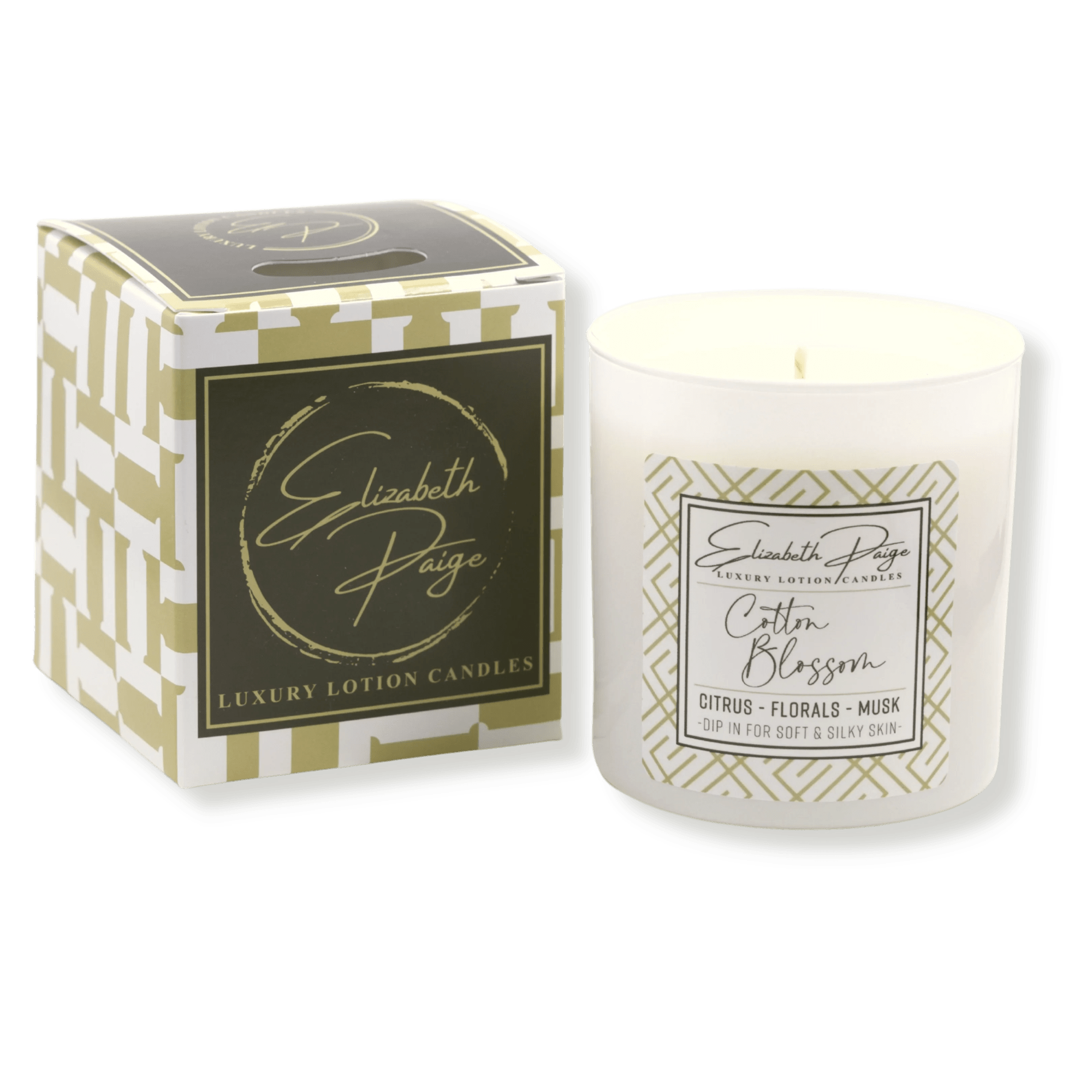 White scented candle in a glass jar beside its patterned gift box