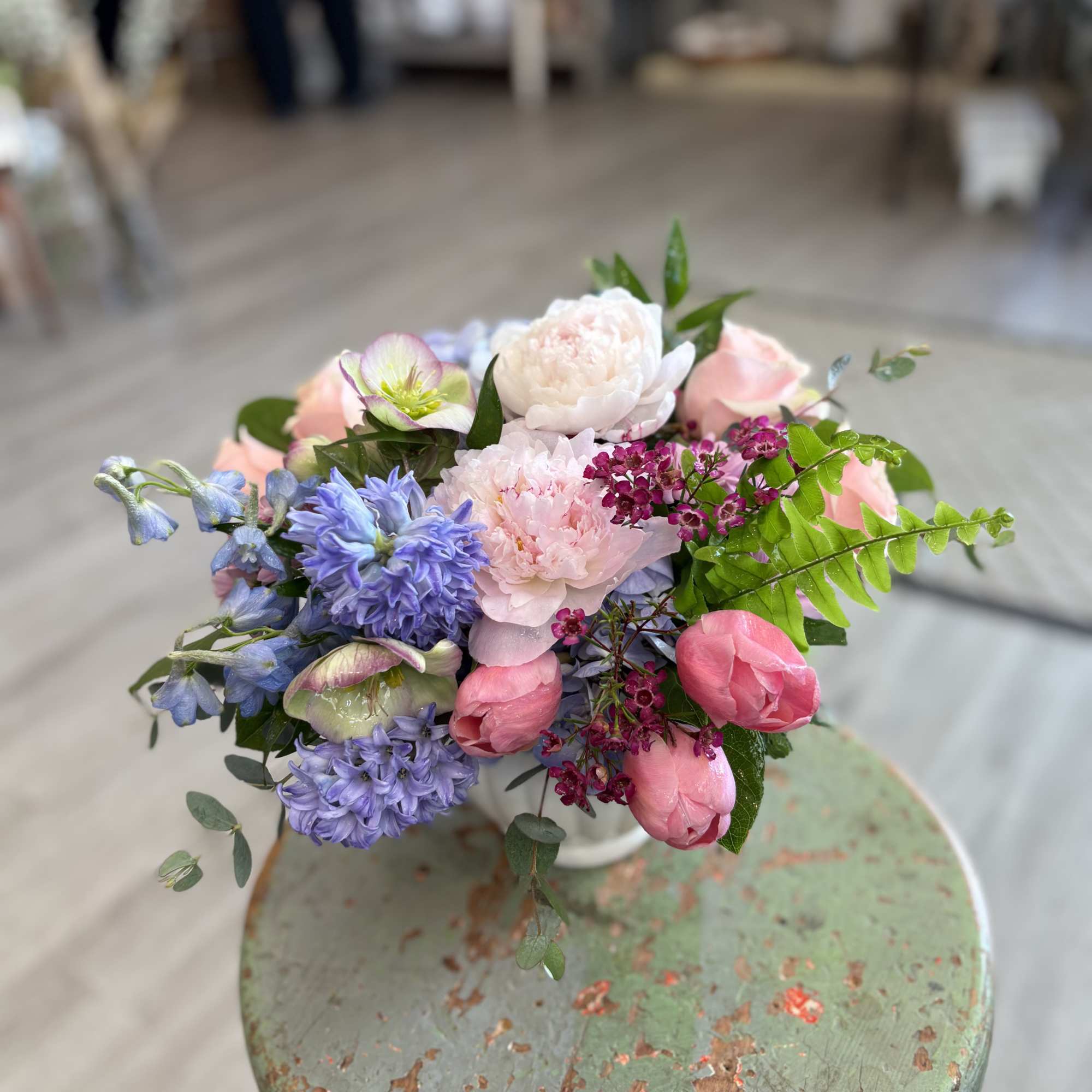 A soft, garden-style arrangement gathered in fresh spring tones. Hydrangea, fragrant hyacinths
