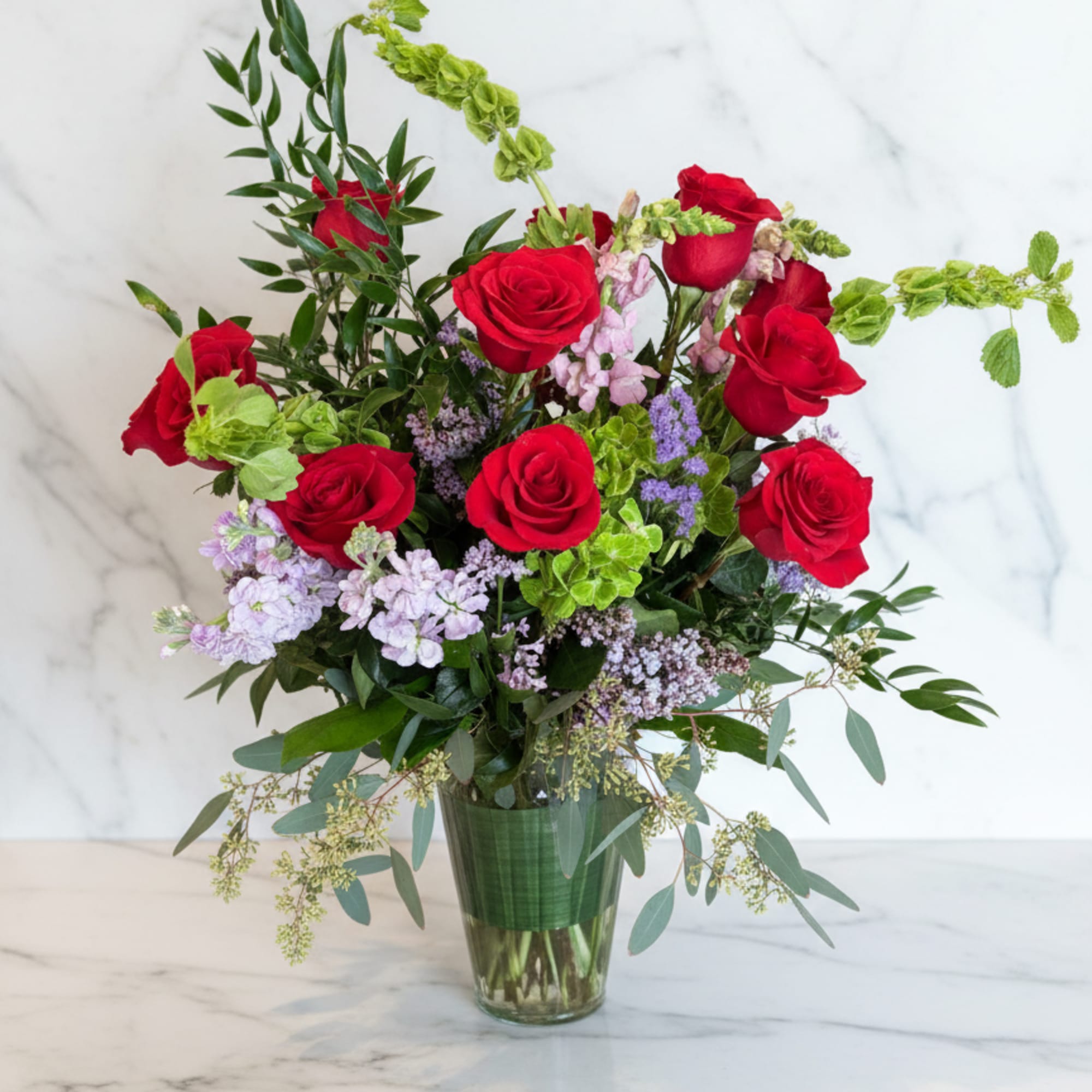 A fresh take on the classic dozen - luxurious red roses designed