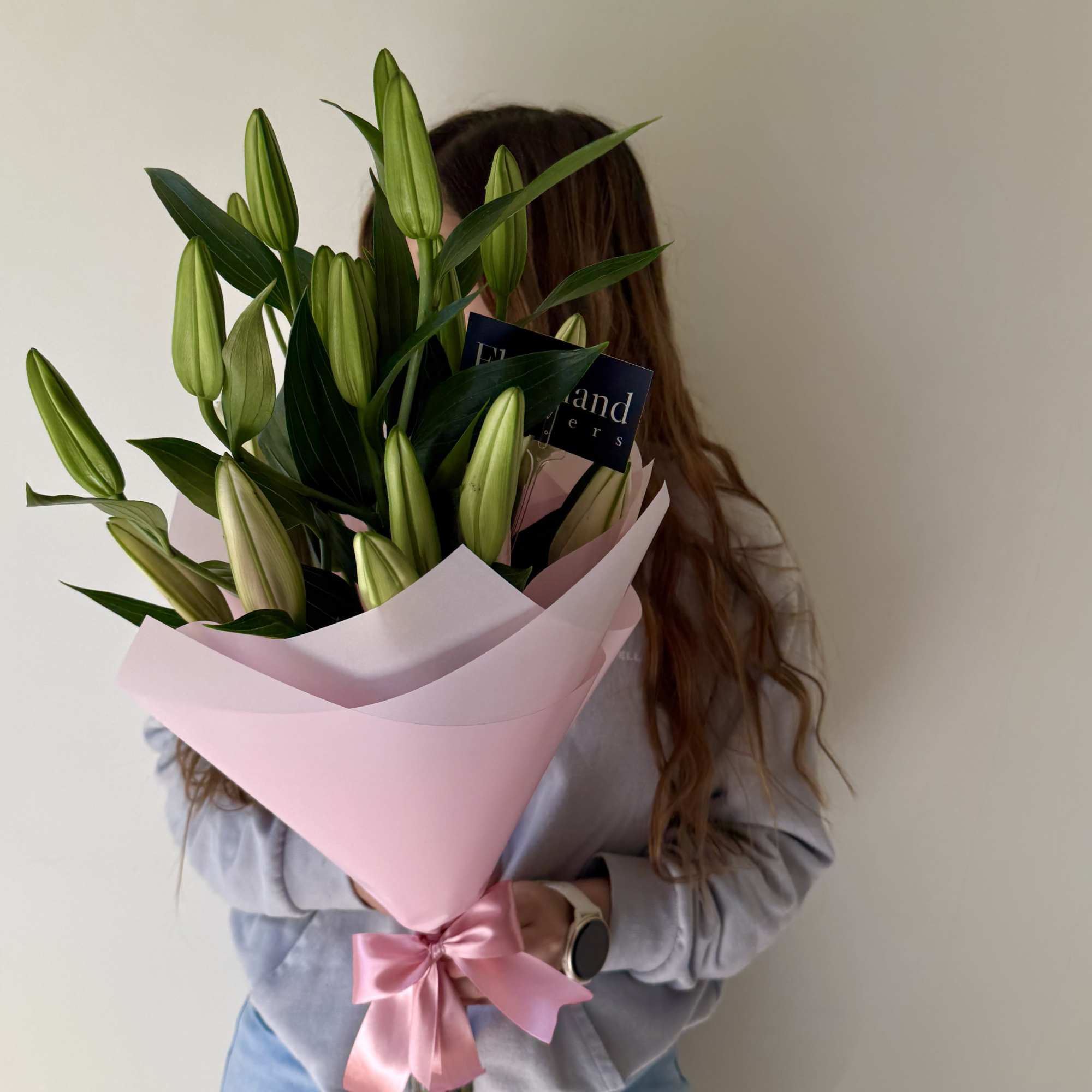A stunning arrangement of majestic, fragrant oriental lilies, elegantly wrapped in delicate