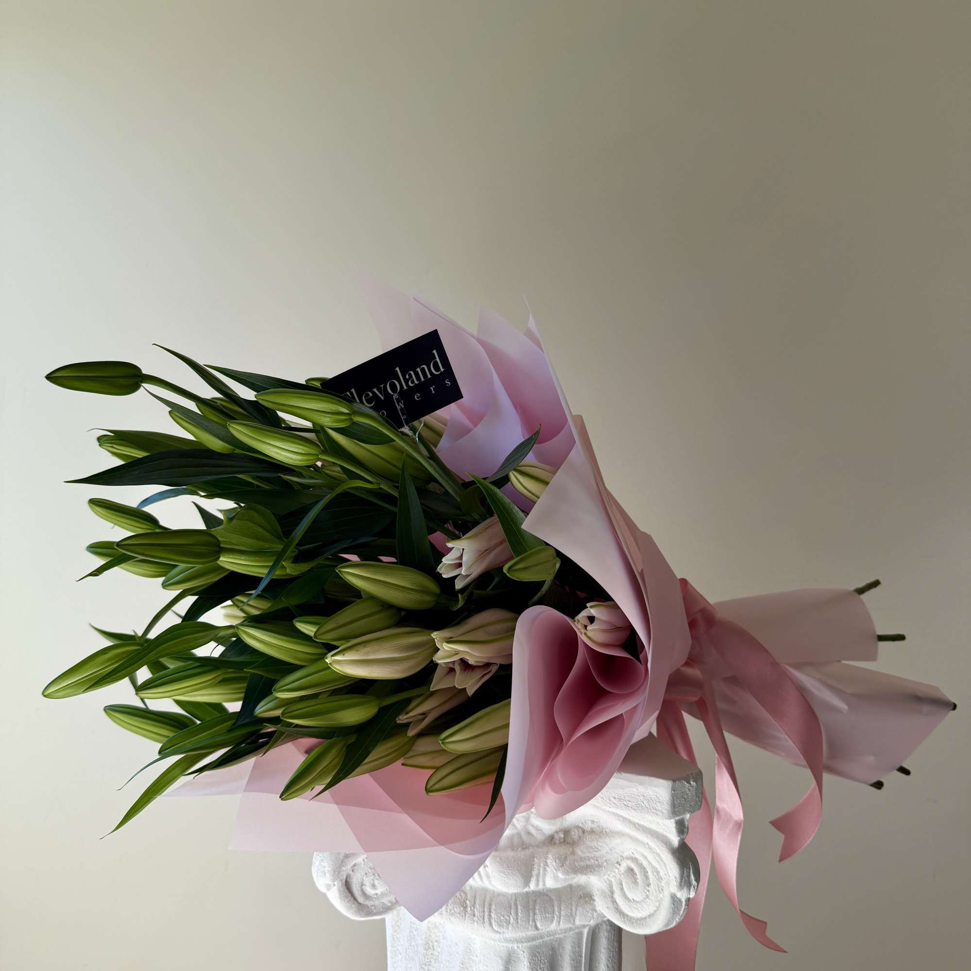 A stunning arrangement of majestic, fragrant oriental lilies, elegantly wrapped in delicate
