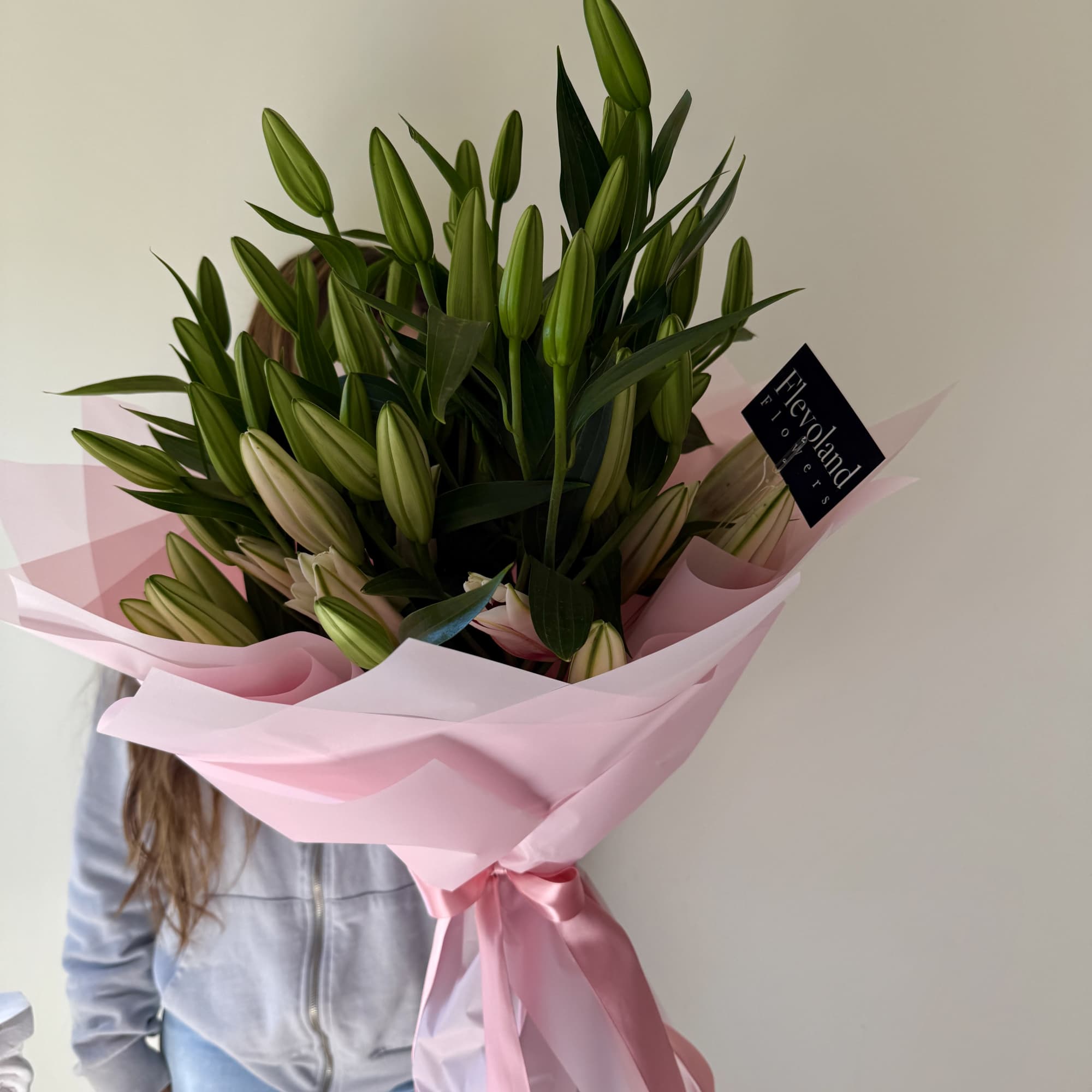 A stunning arrangement of majestic, fragrant oriental lilies, elegantly wrapped in delicate