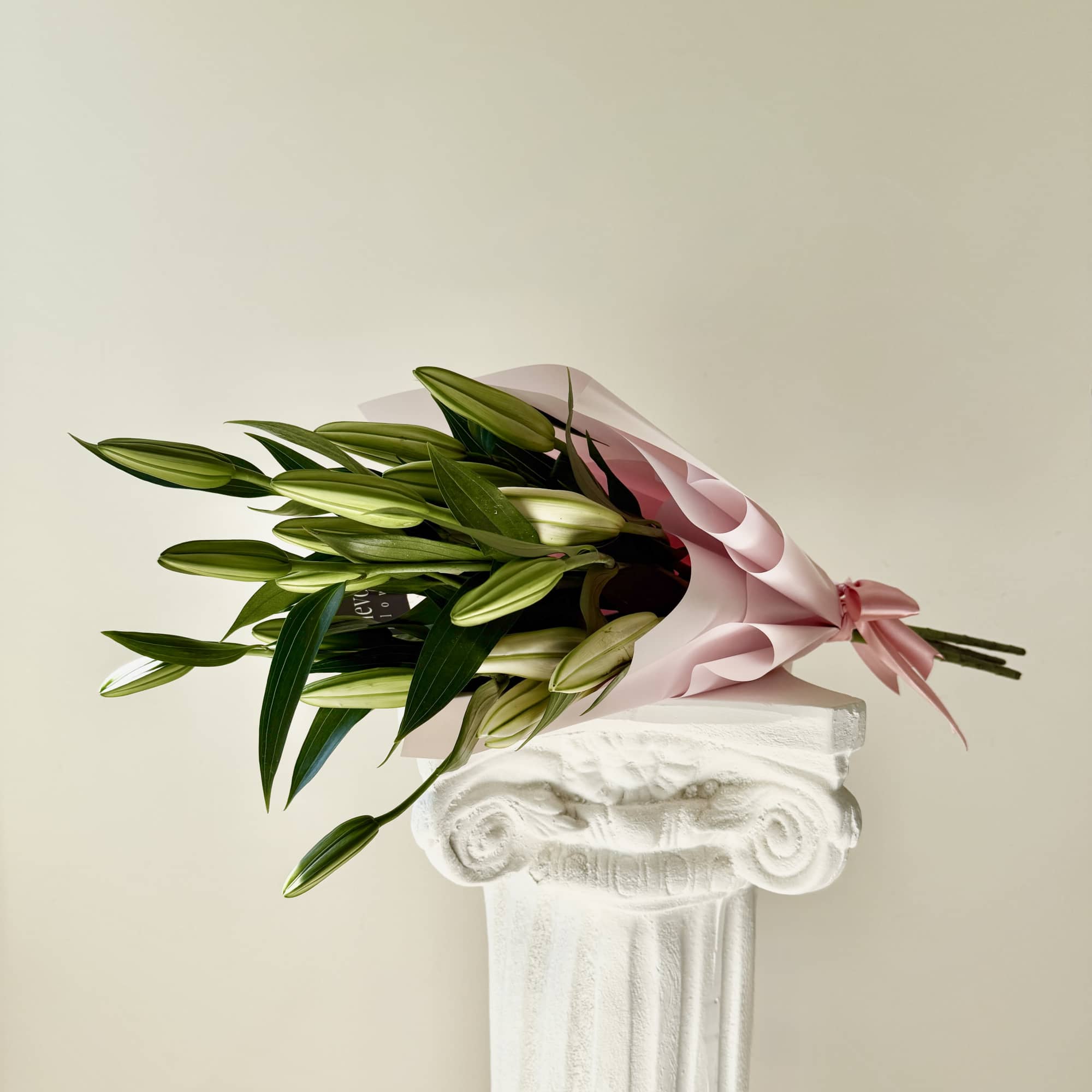 A stunning arrangement of majestic, fragrant oriental lilies, elegantly wrapped in delicate