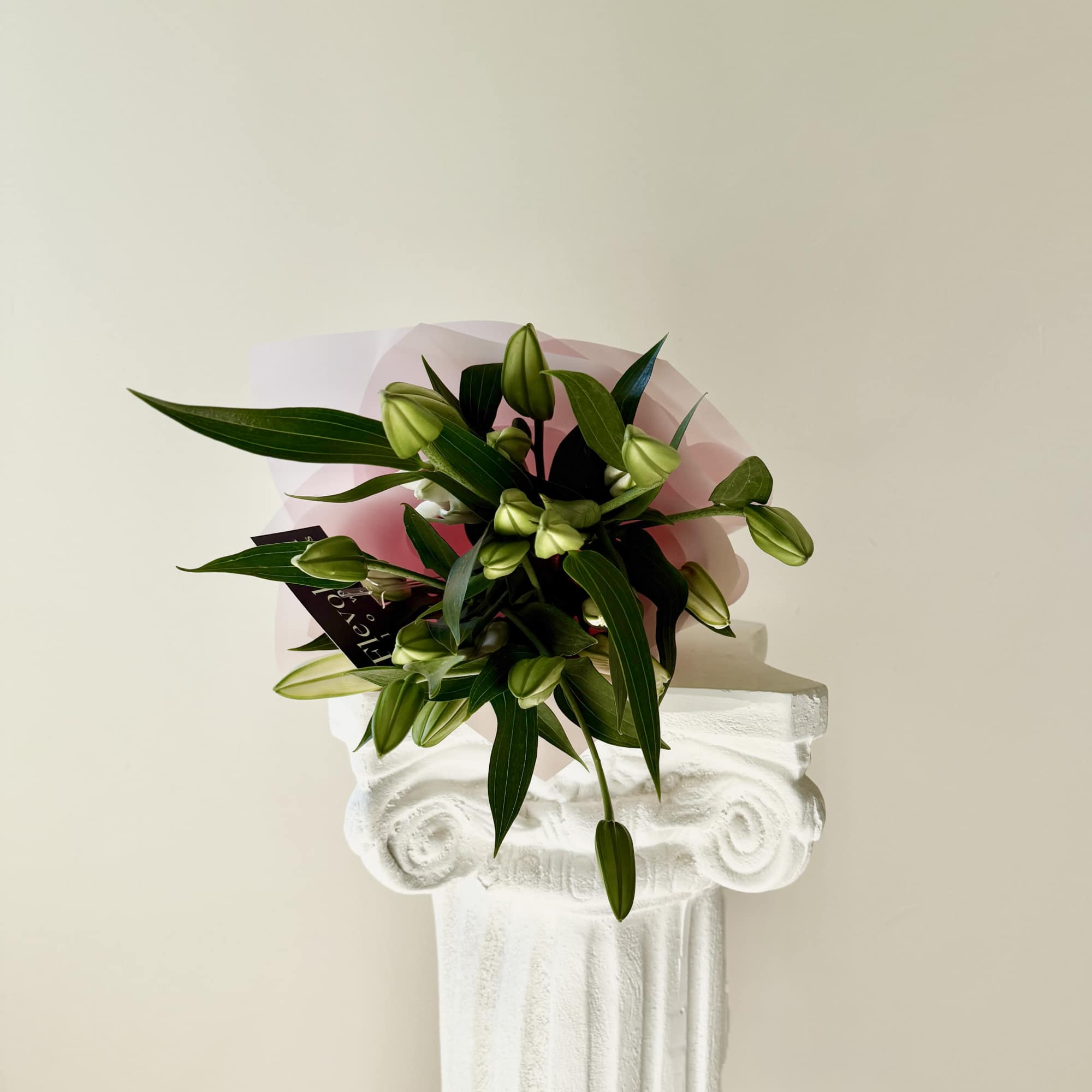A stunning arrangement of majestic, fragrant oriental lilies, elegantly wrapped in delicate