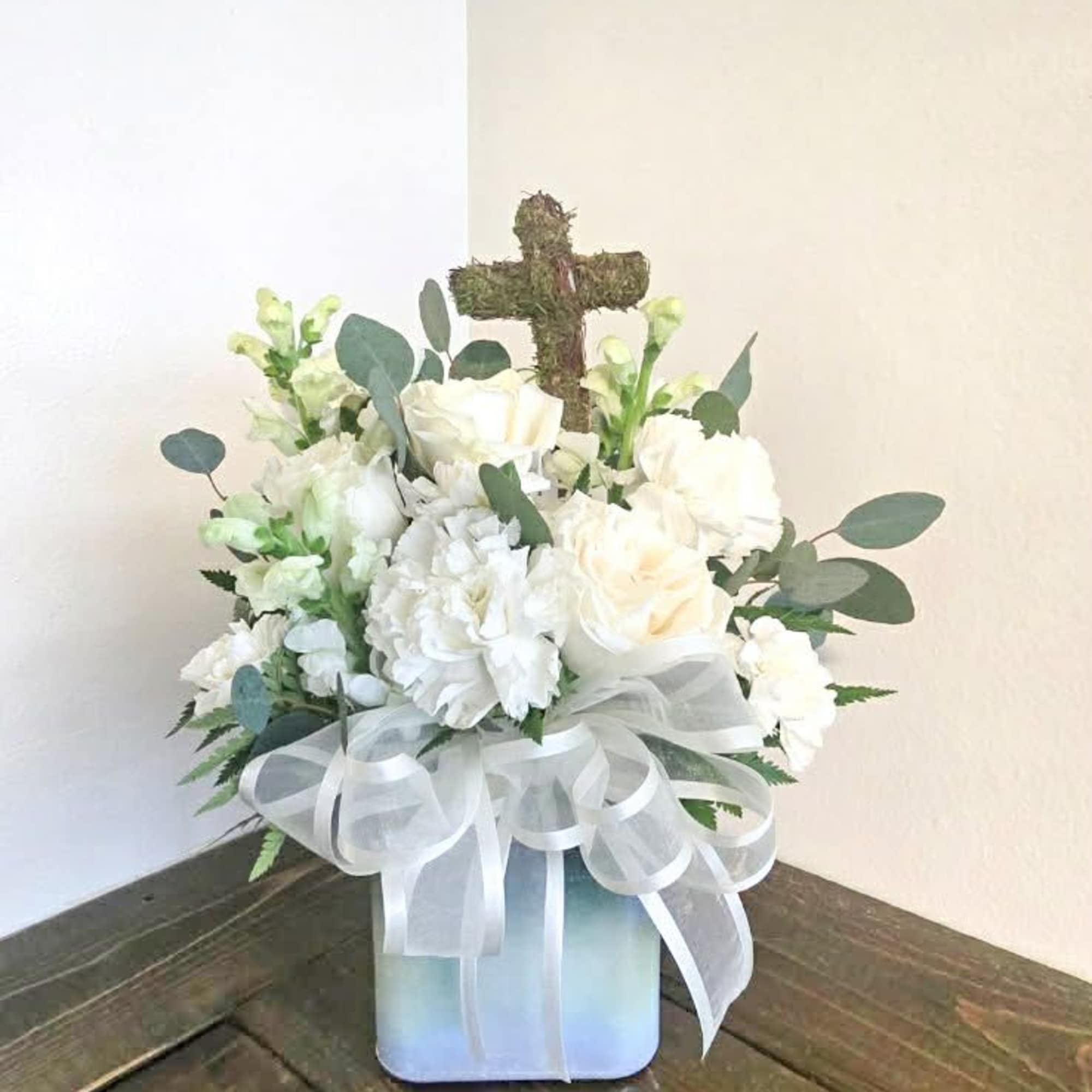Faith is an all white arrangement full of white blooms, eucalyptus and
