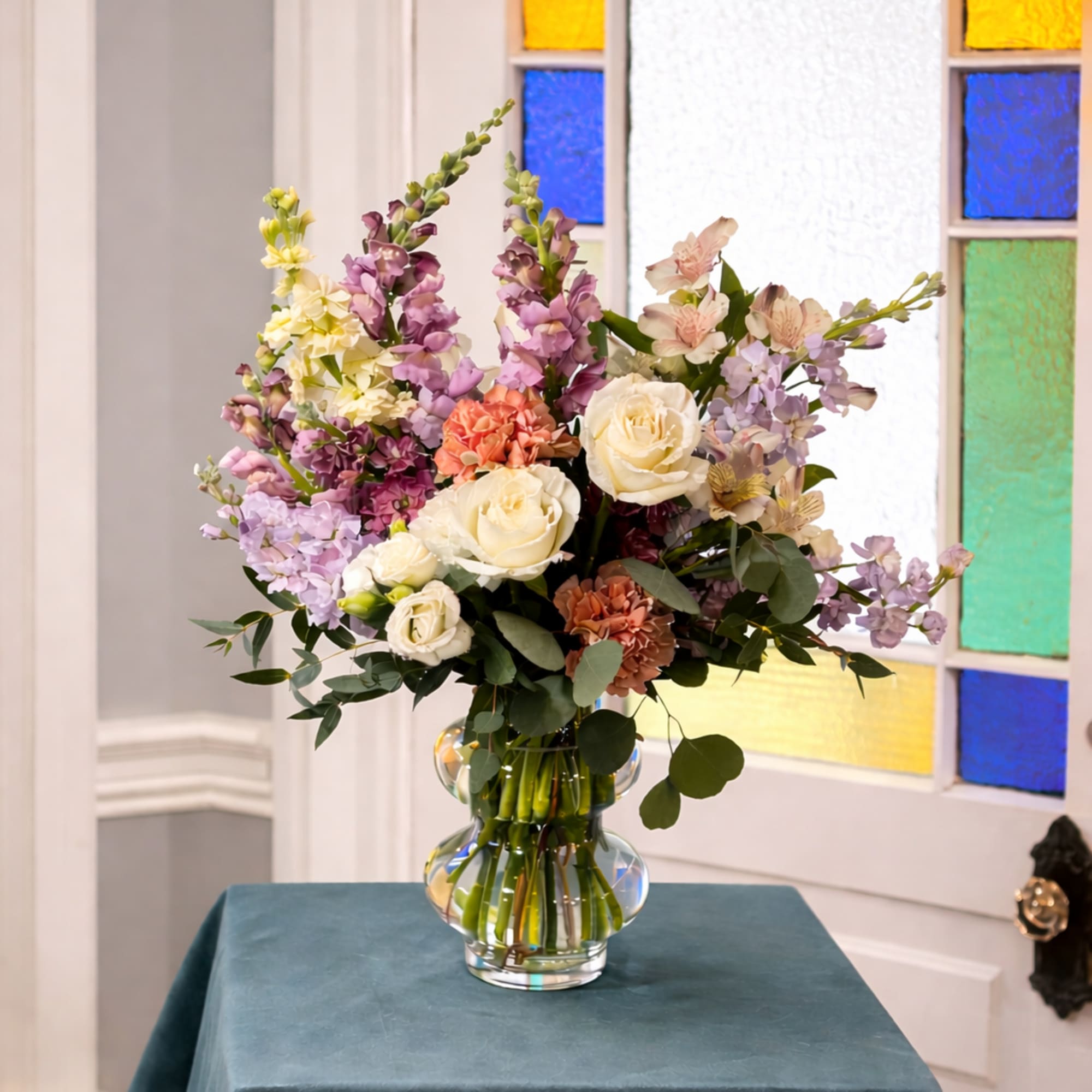 Garden Celebration is a vibrant, garden-style floral arrangement created to mark meaningful