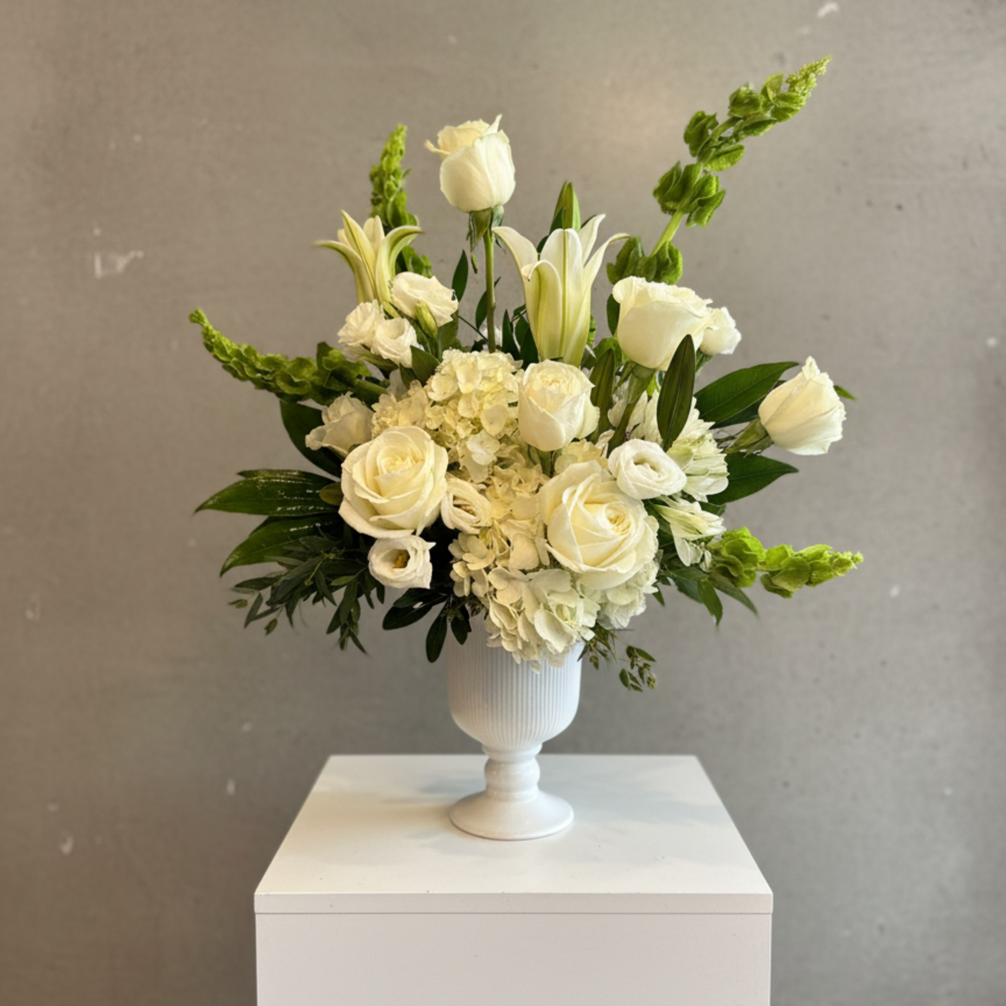 Graceful Tribute is a timeless sympathy arrangement designed to honor life, express