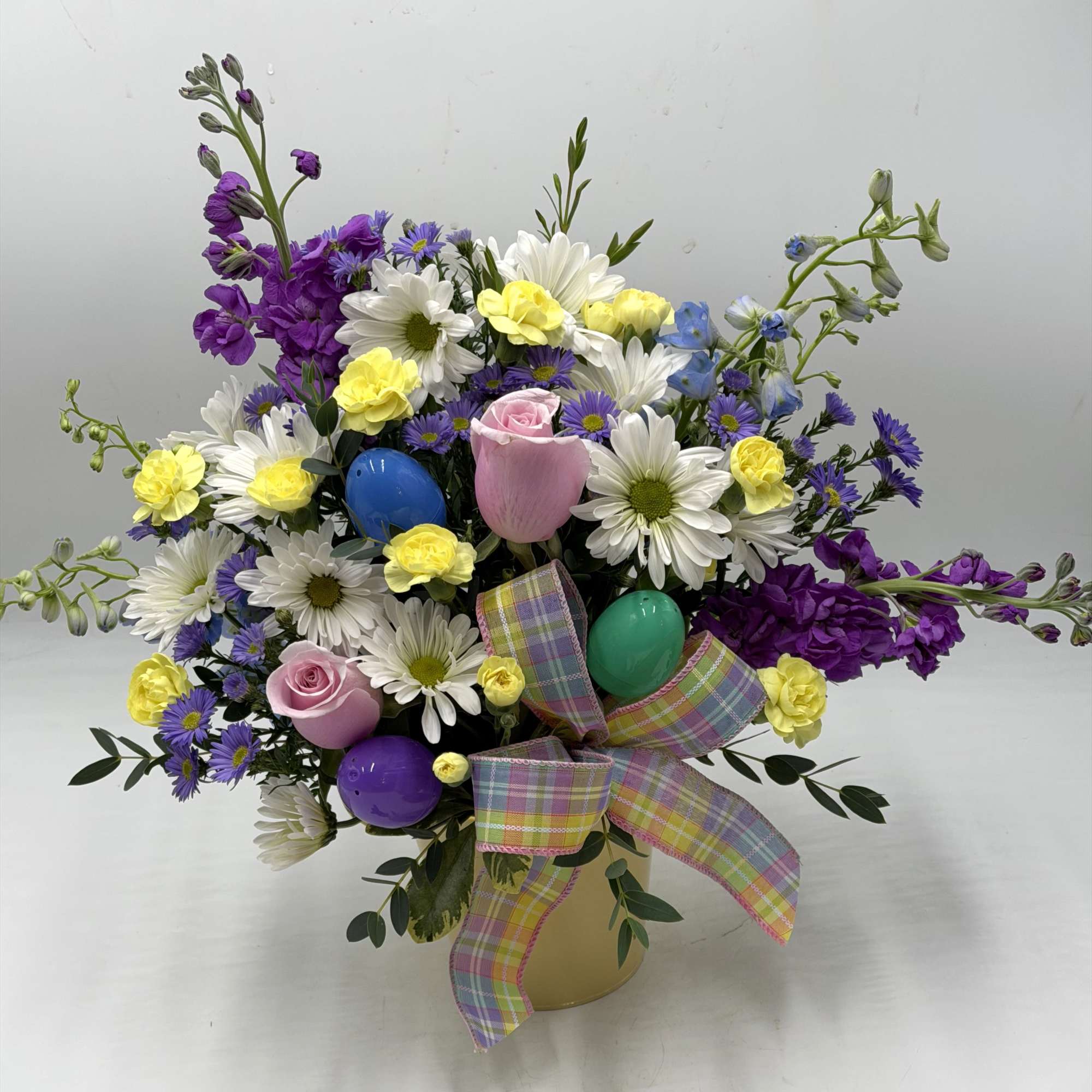 This garden-inspired arrangement bursts with fresh color and playful charm. Perfect for