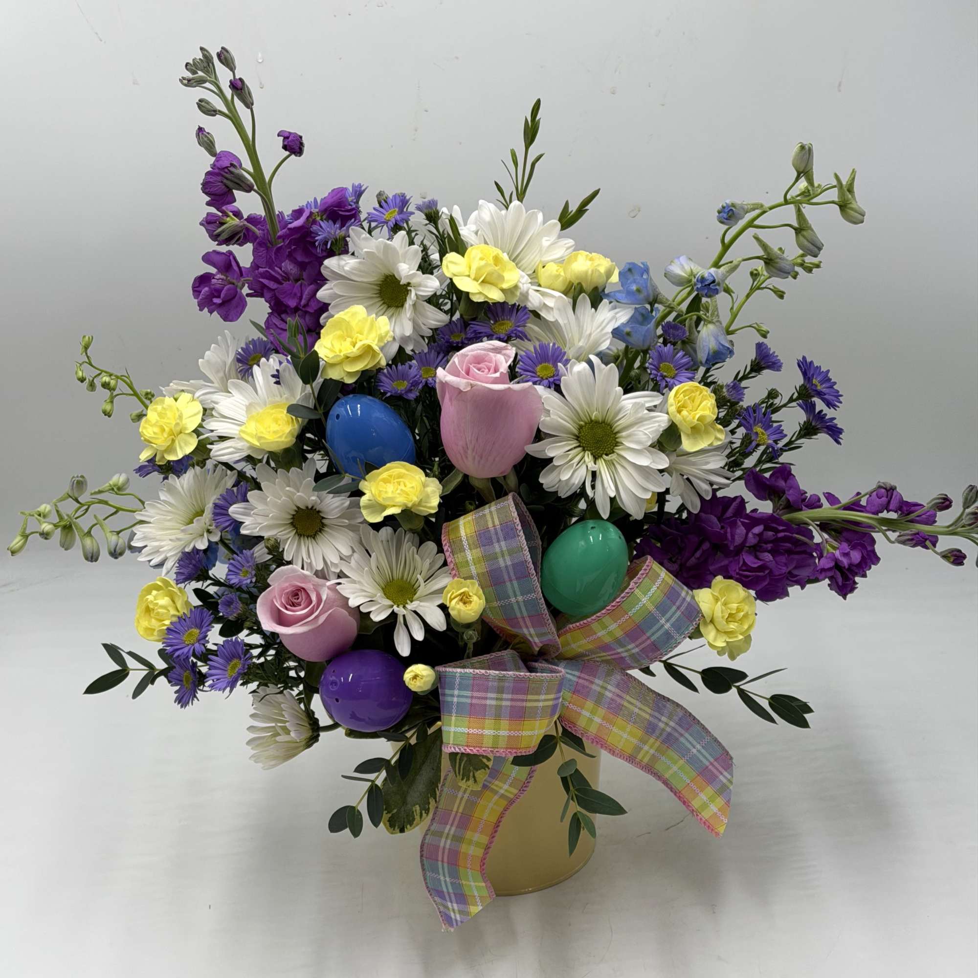 This garden-inspired arrangement bursts with fresh color and playful charm. Perfect for