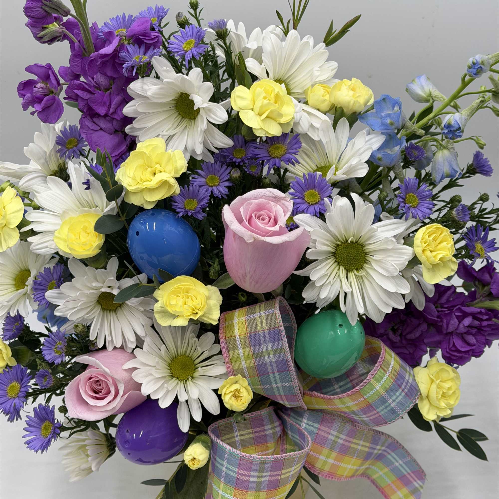 This garden-inspired arrangement bursts with fresh color and playful charm. Perfect for