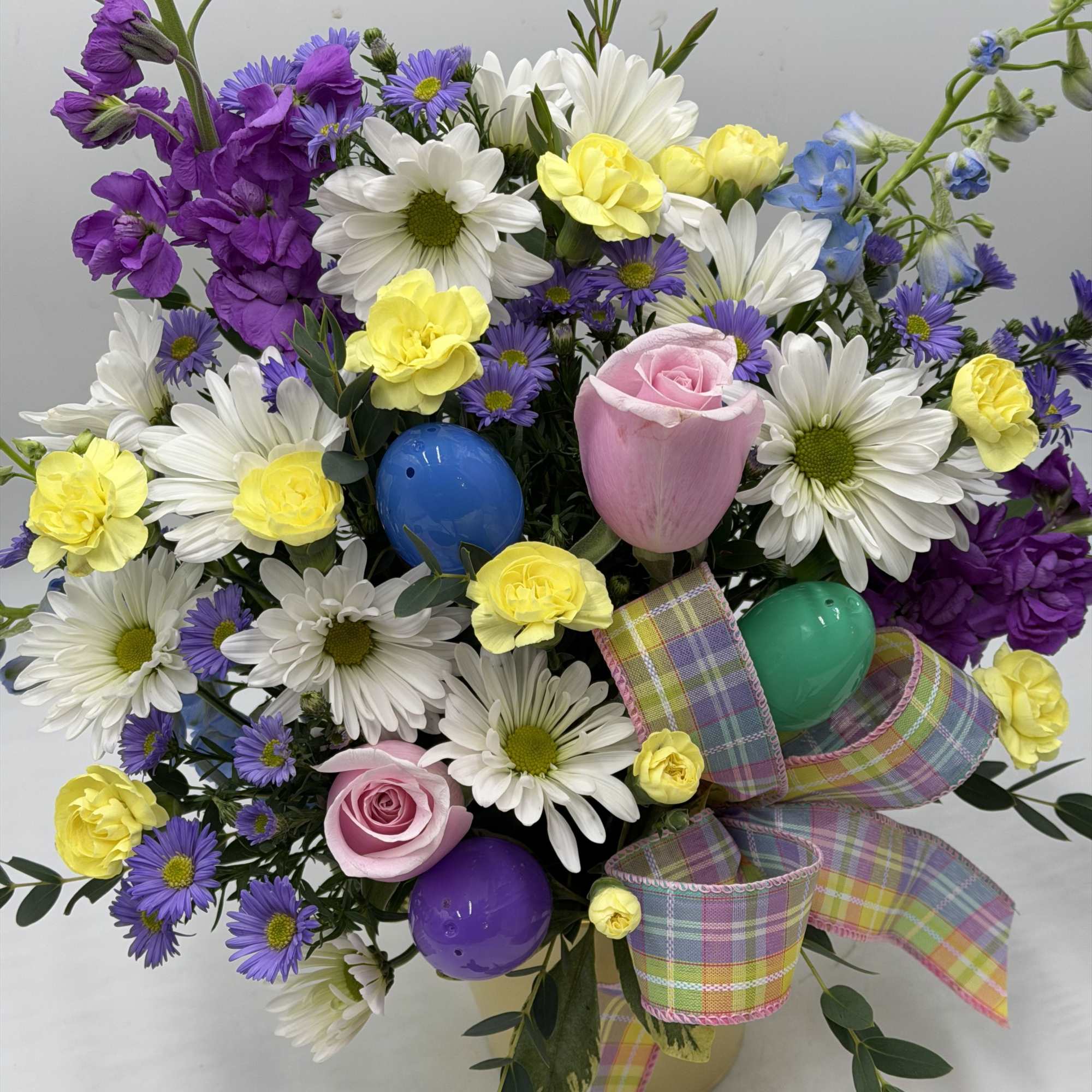 This garden-inspired arrangement bursts with fresh color and playful charm. Perfect for