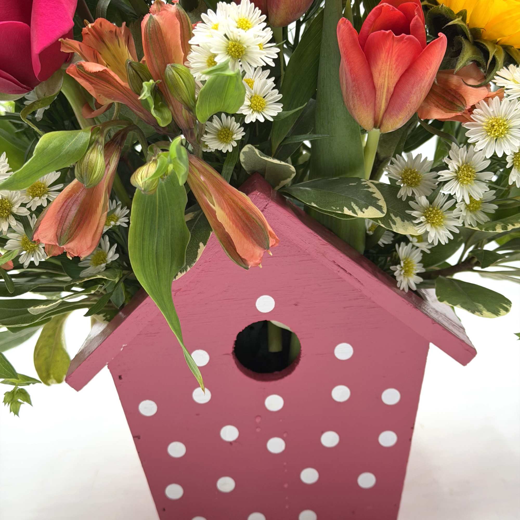 A cheerful, garden - inspired arrangement bursting with color and charm artfully