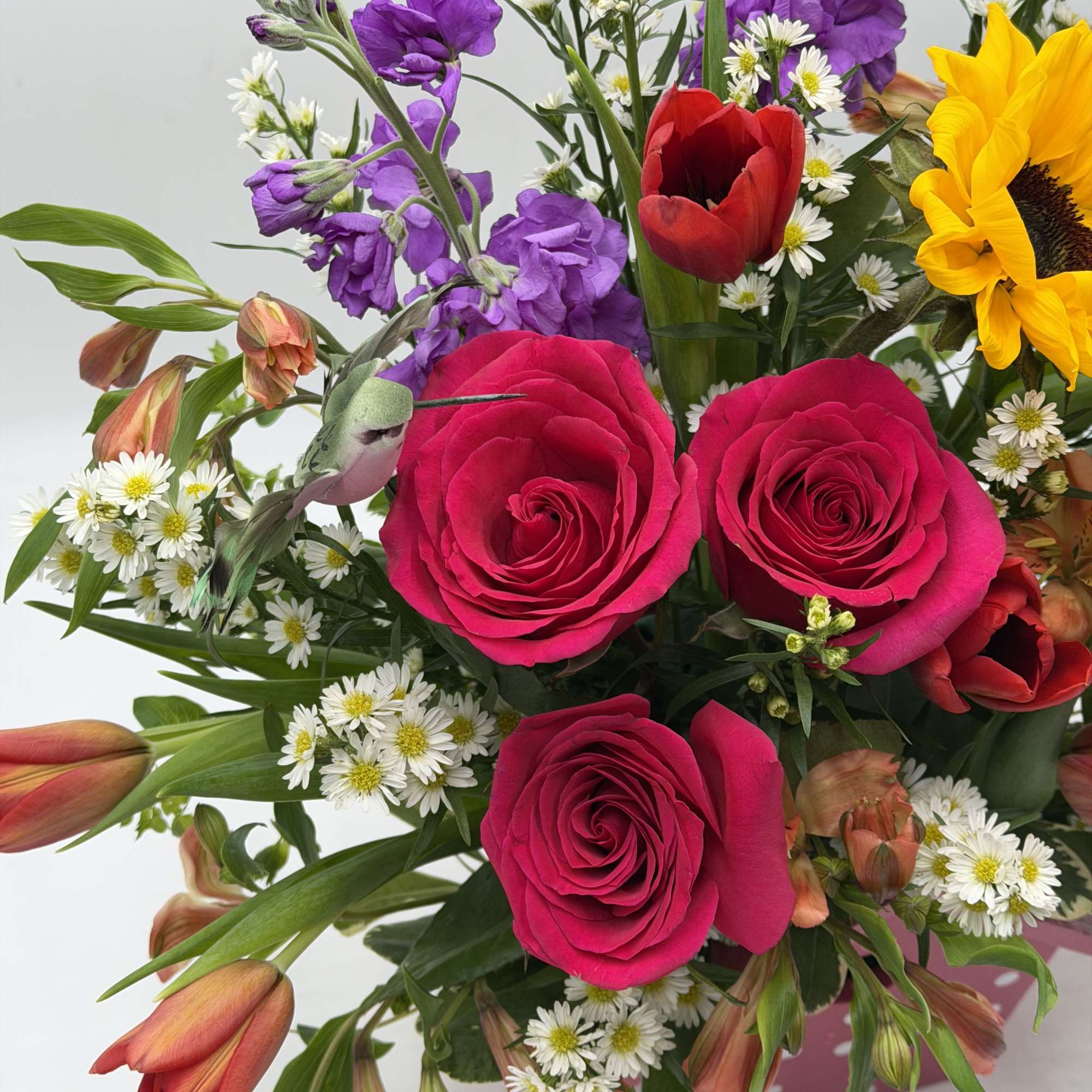 A cheerful, garden - inspired arrangement bursting with color and charm artfully