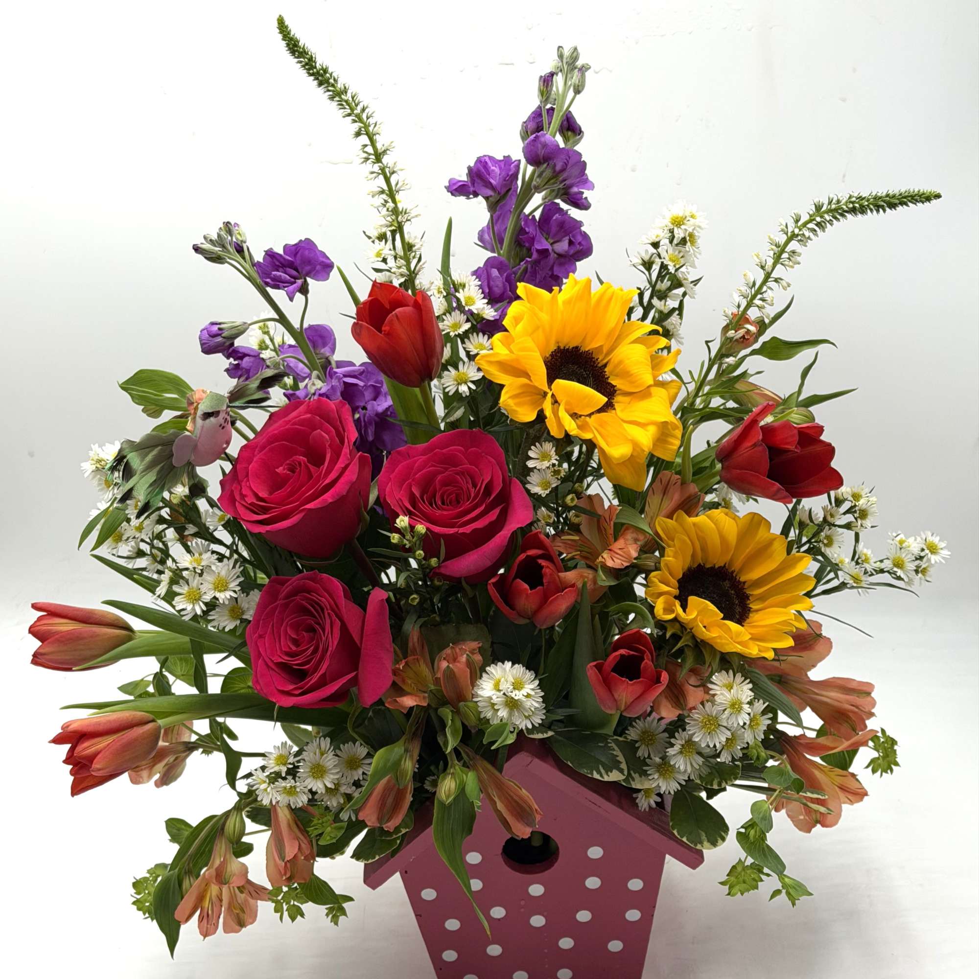 A cheerful, garden - inspired arrangement bursting with color and charm artfully