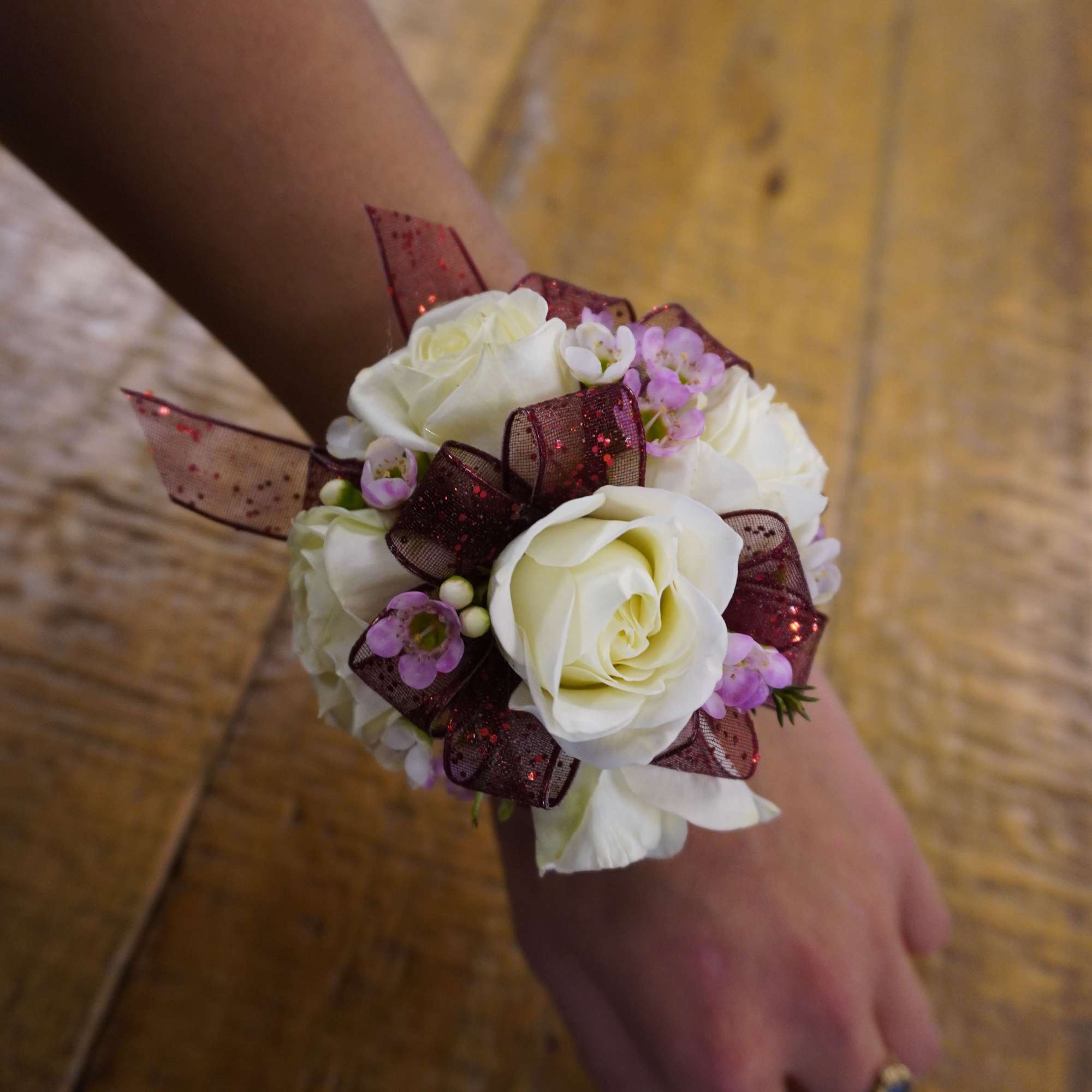 Delicately crafted corsages made with mini roses, filler, small touches of greenery