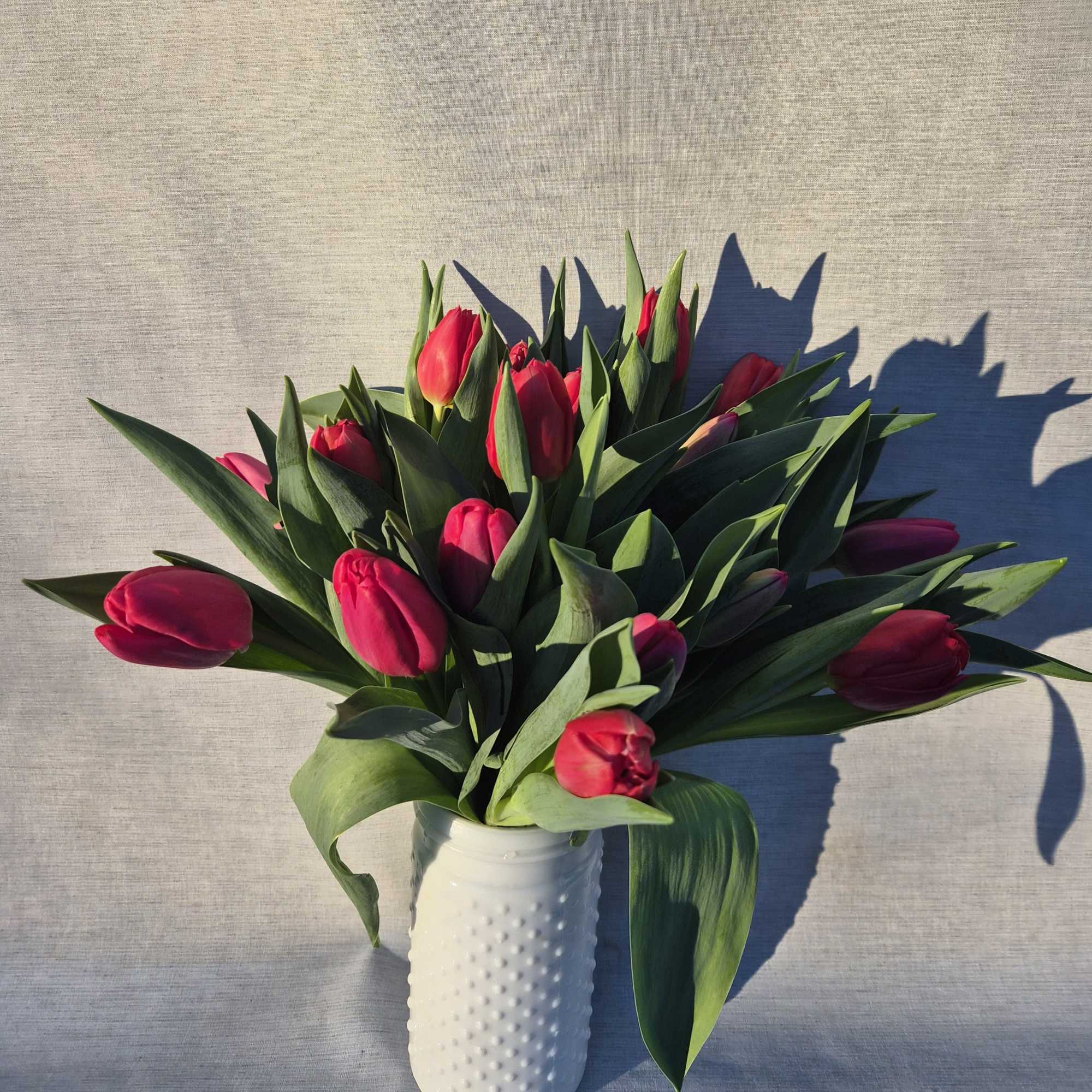 20 Local Tulips in a white hobnail vase 
You can specify a