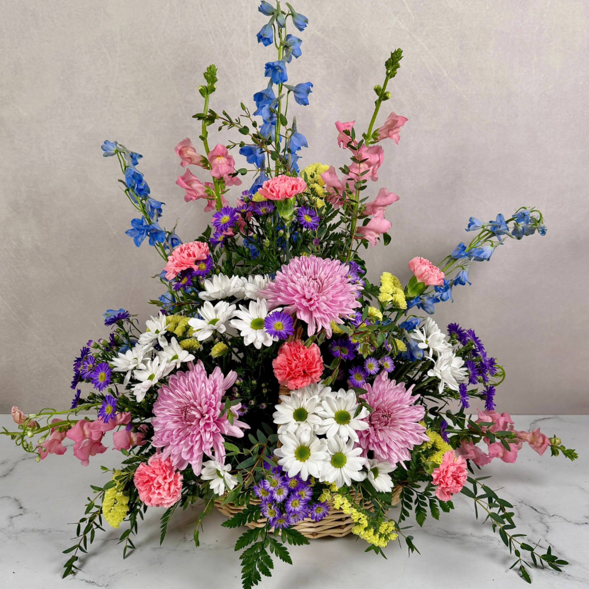 Soft, garden-fresh colors and a gentle, arching silhouette make this flower arrangement