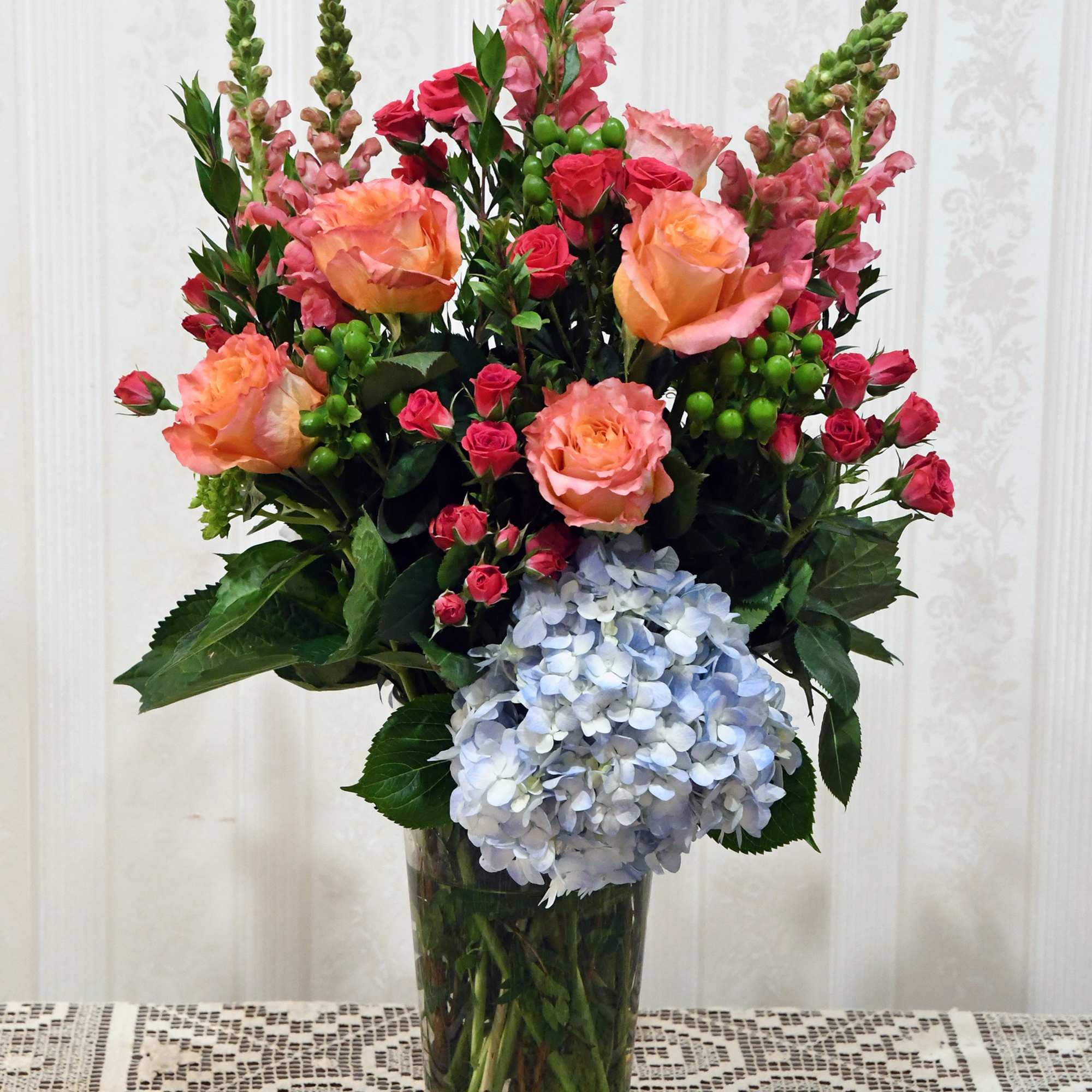 A gorgeous collection of vibrant color.  Bright roses, snapdragon, spray roses