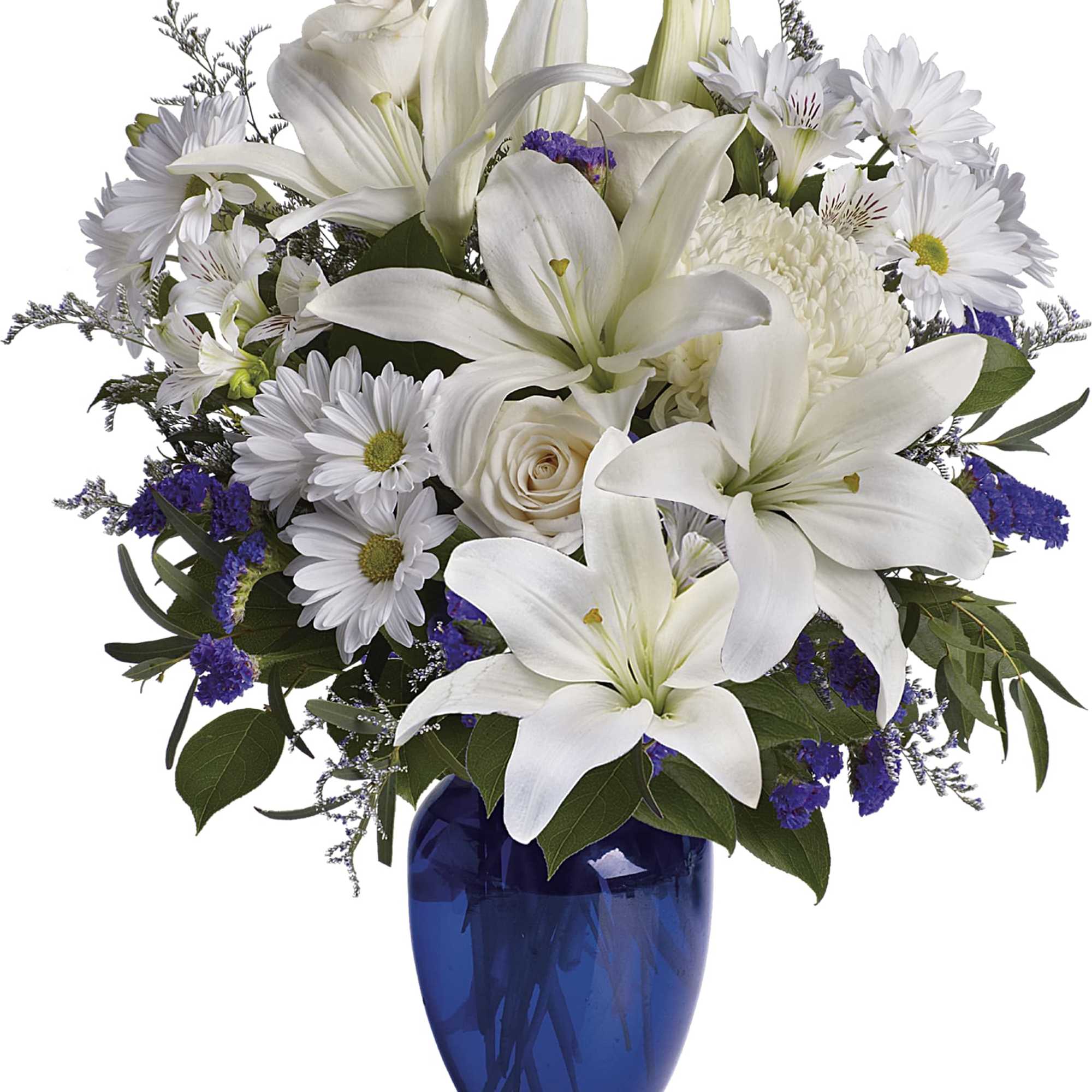 White lilies and daisies arranged in a blue glass vase