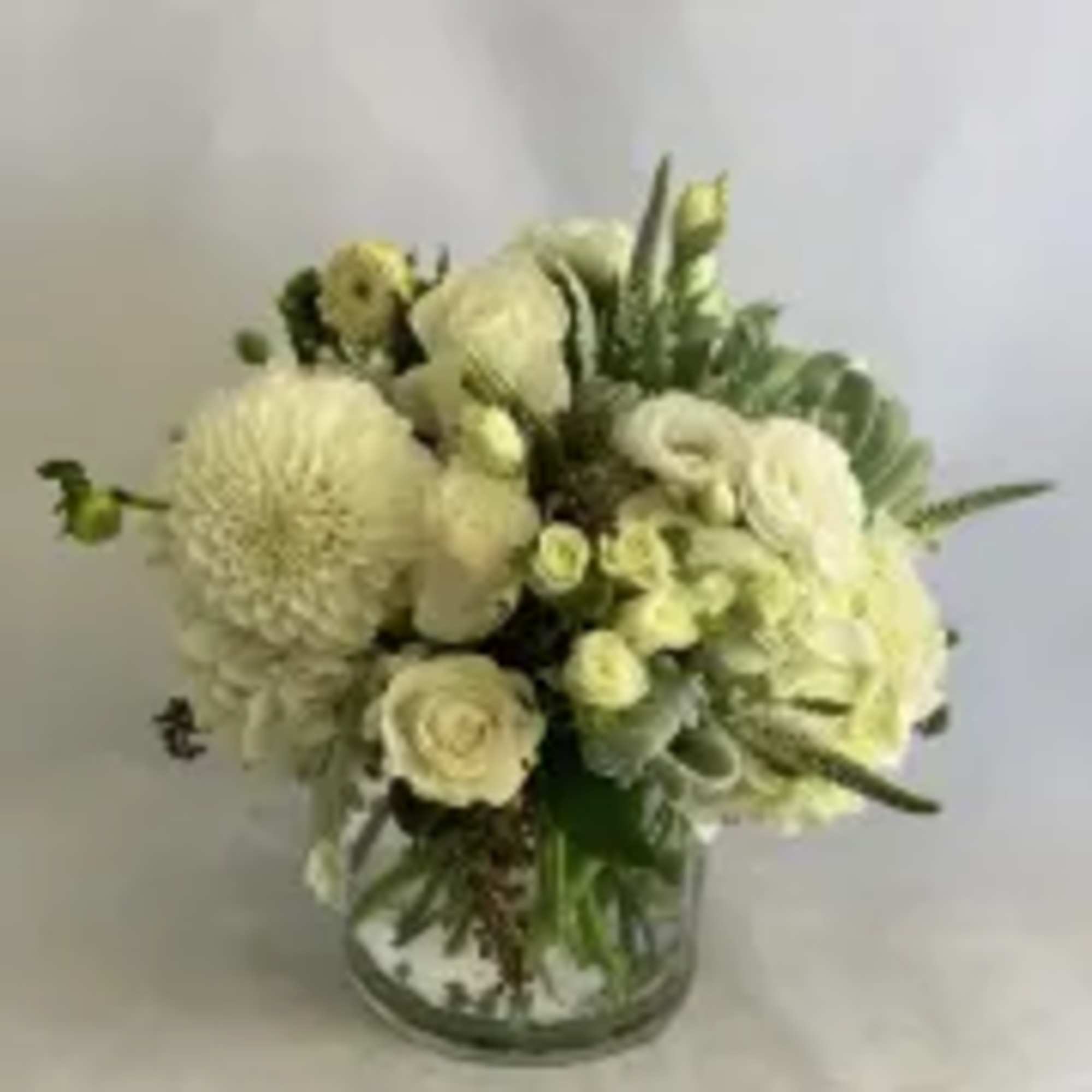 This elegant arrangement features beautiful seasonal white flowers and succulents.
Second picture is