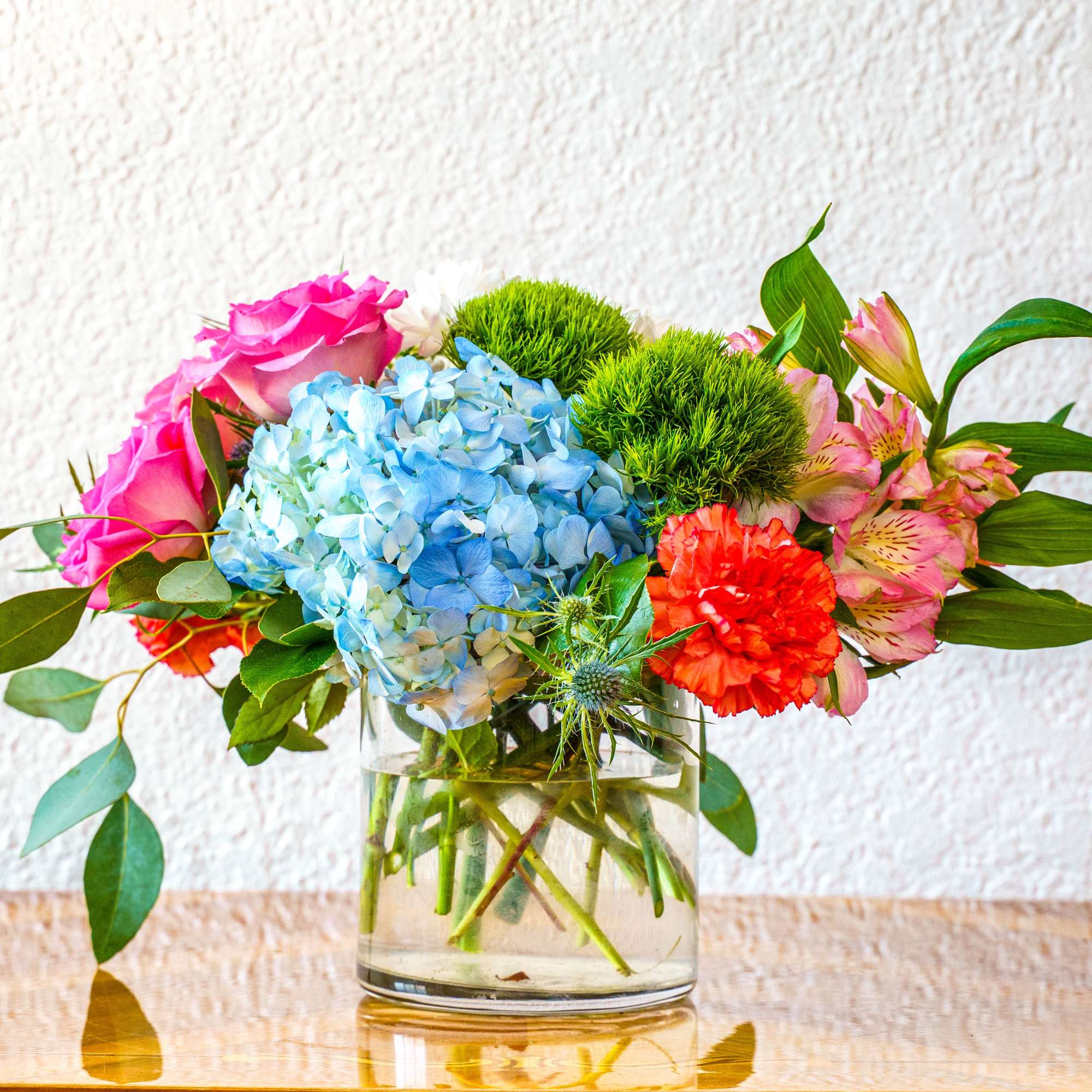 Delight them with this wonderful assortment of colorful blooms. Perfect for corporate